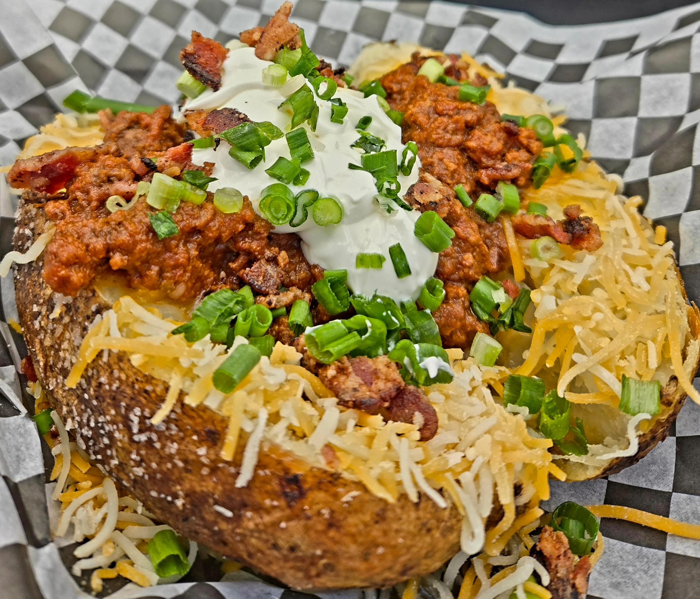 Delicious gourmet burger with fresh toppings on a wooden table