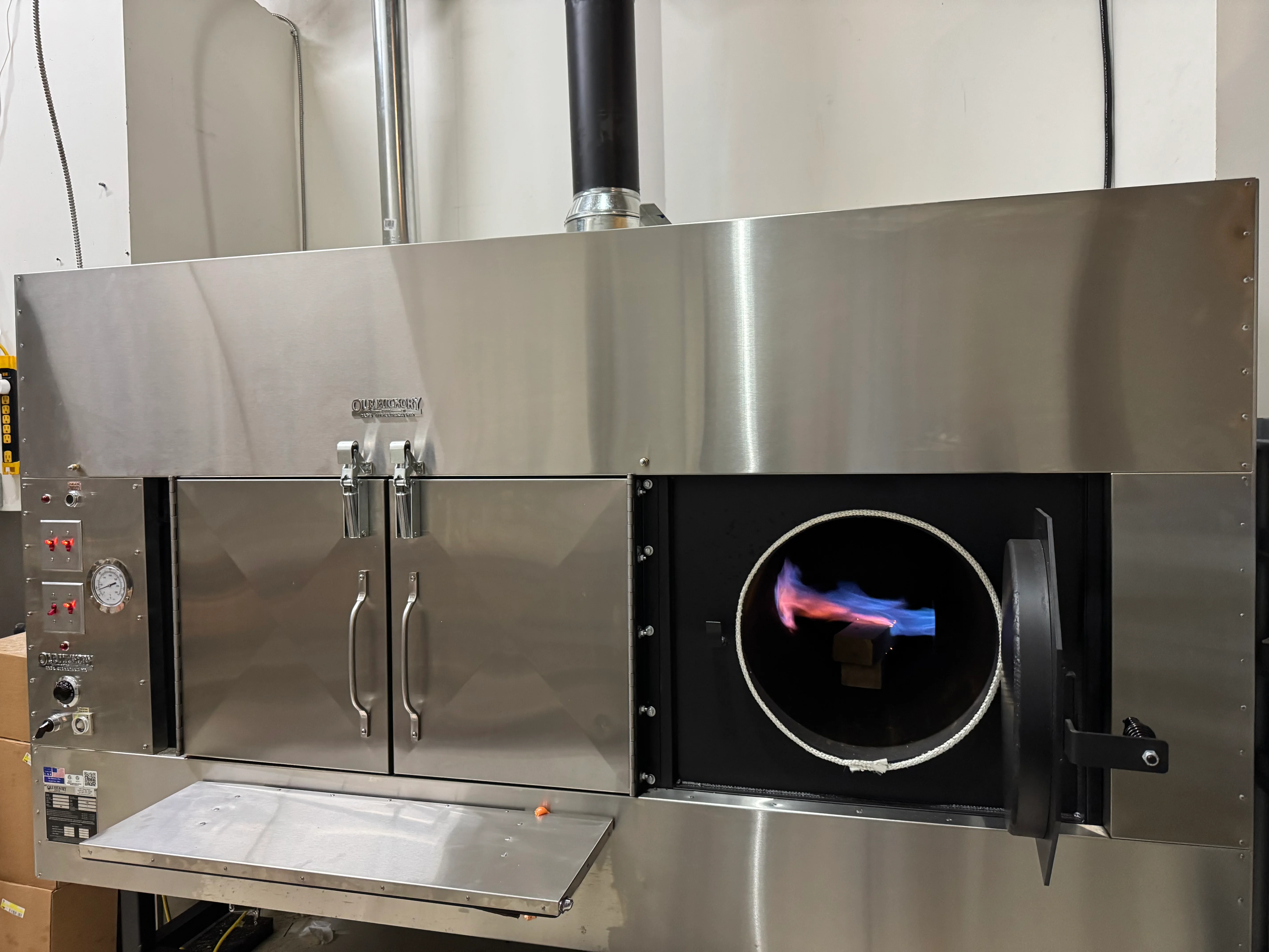 Commercial wood-fired oven with flames
