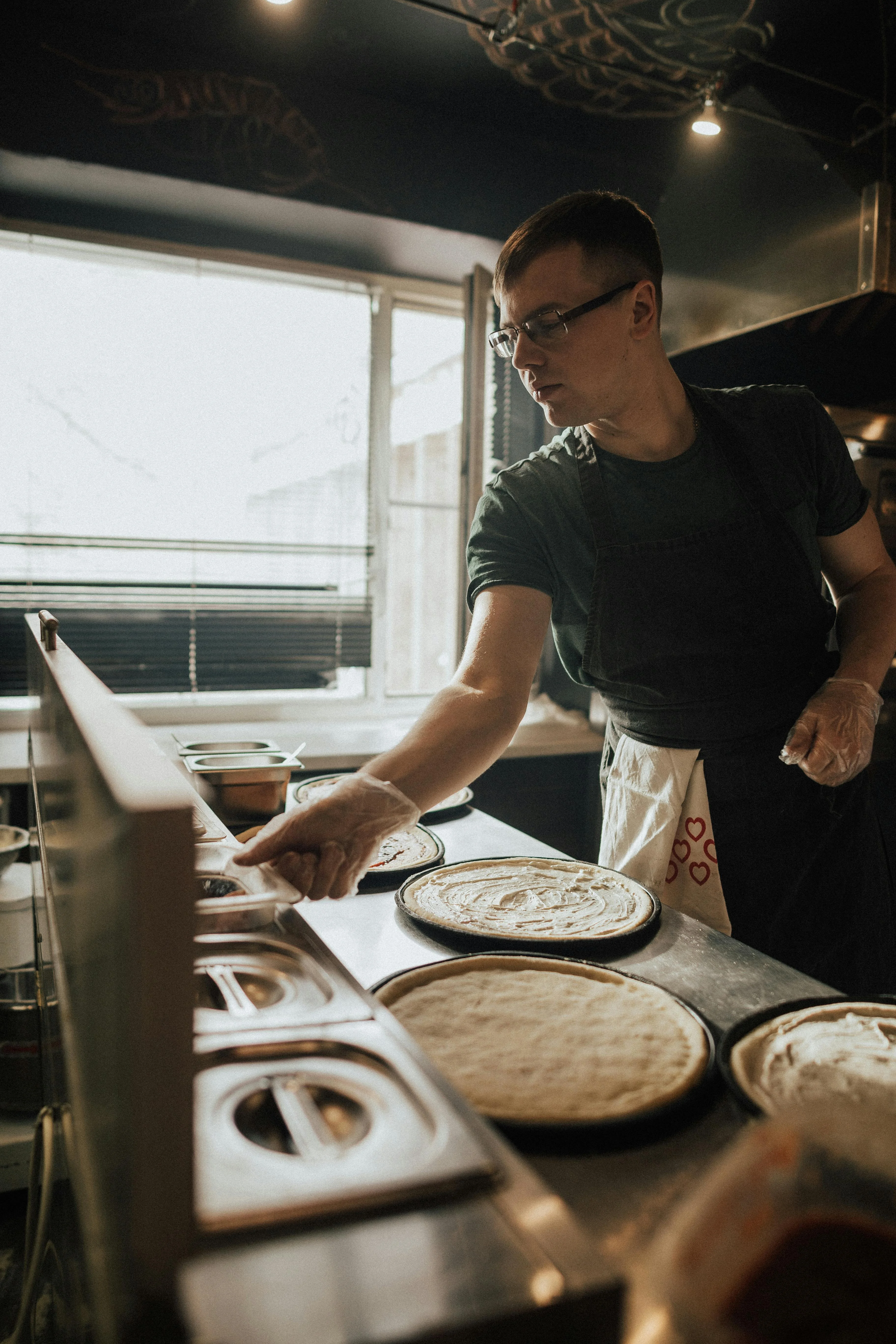 Chef preparing pizza dough in a modern kitchen