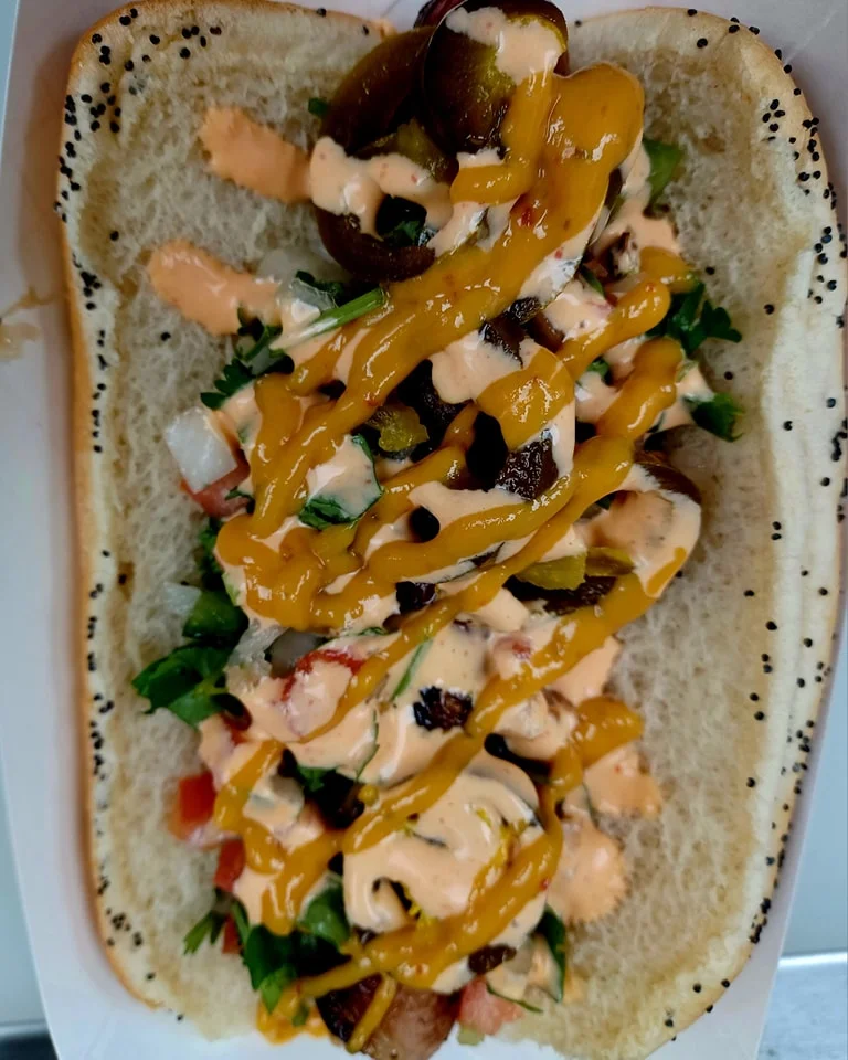 Loaded Mexican-style hot dog with toppings