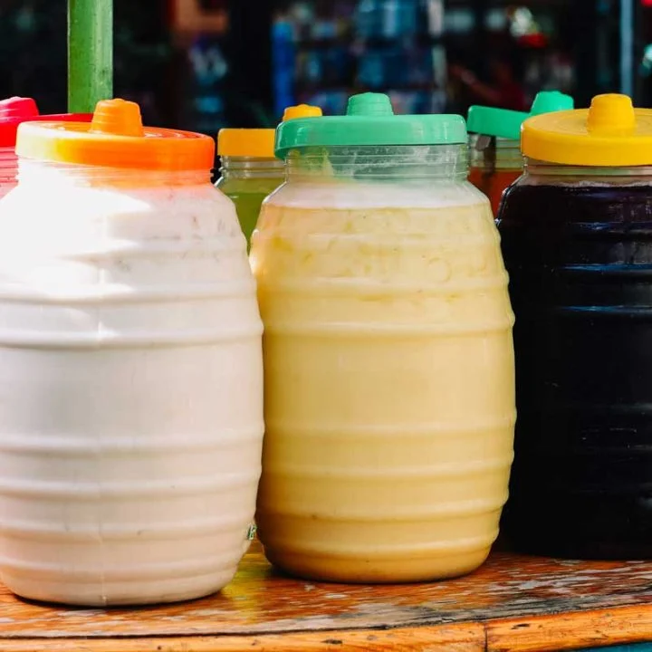 Colorful jars of traditional sauces at a street food market