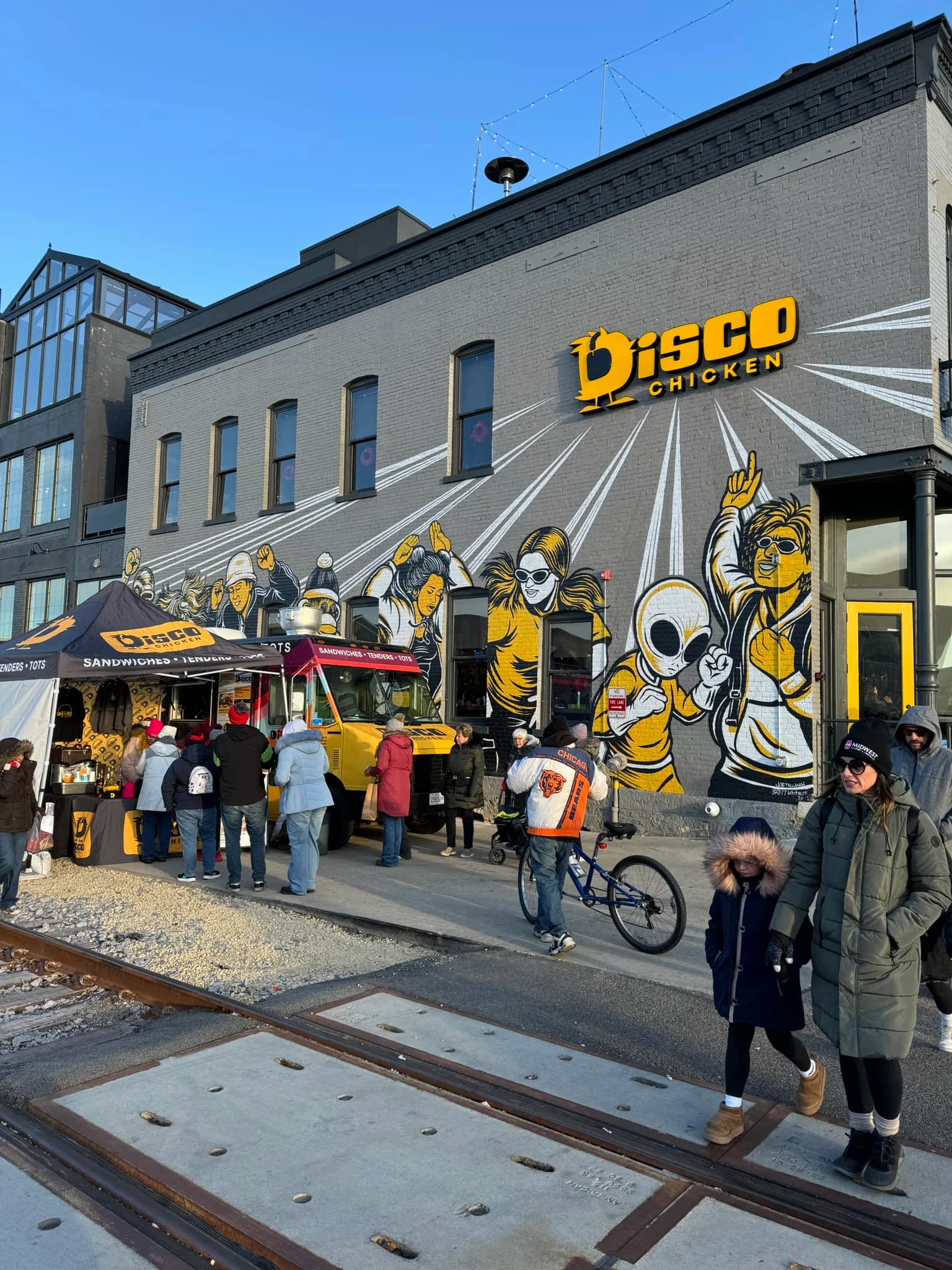 Vibrant food truck scene at Disco Chicken with mural art