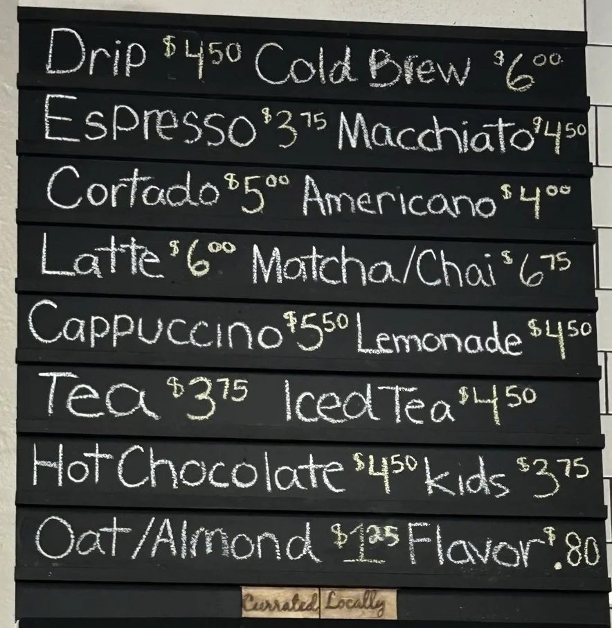 Coffee menu board featuring various beverages and prices
