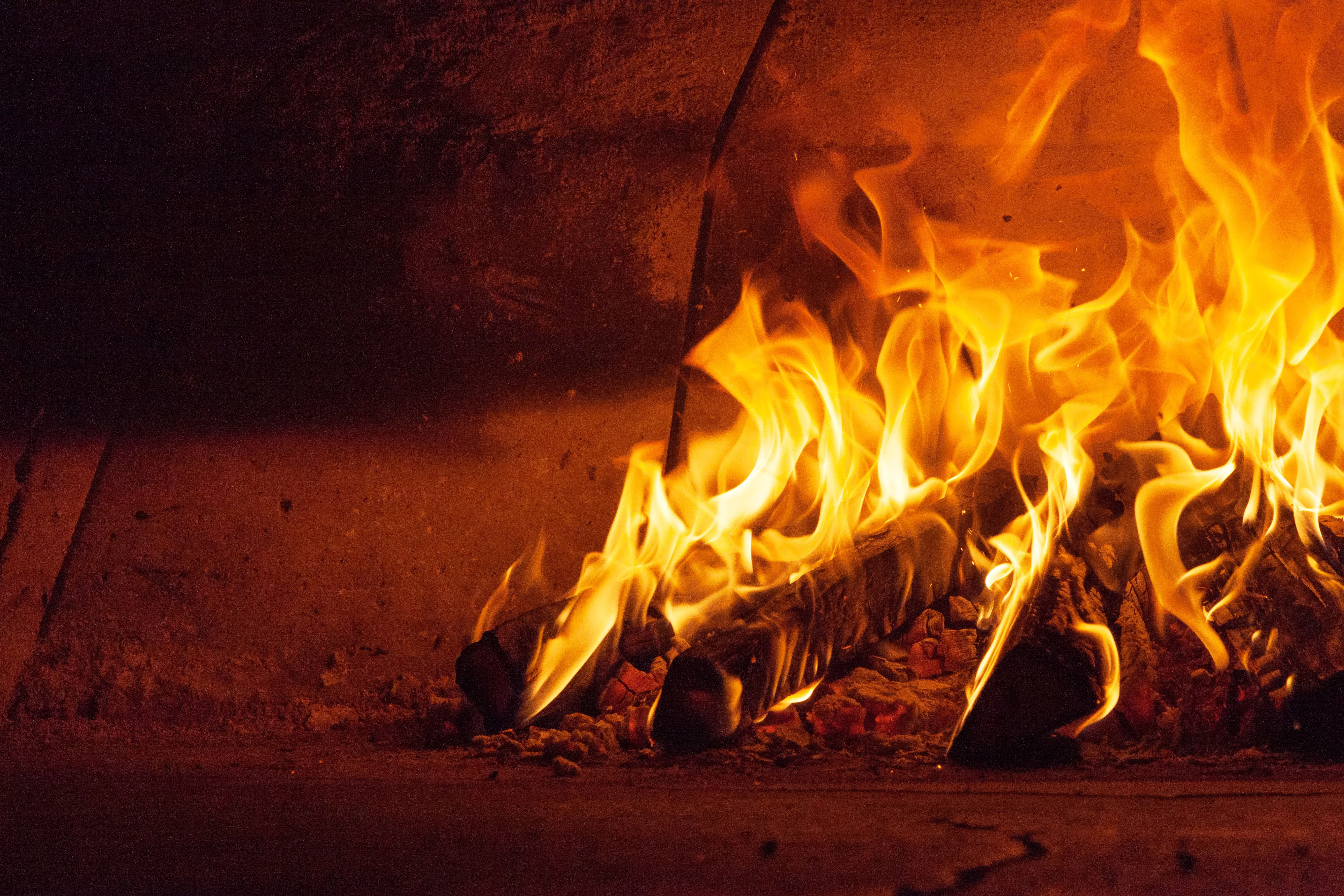 Flames dancing in a wood-fired oven, creating a warm ambiance