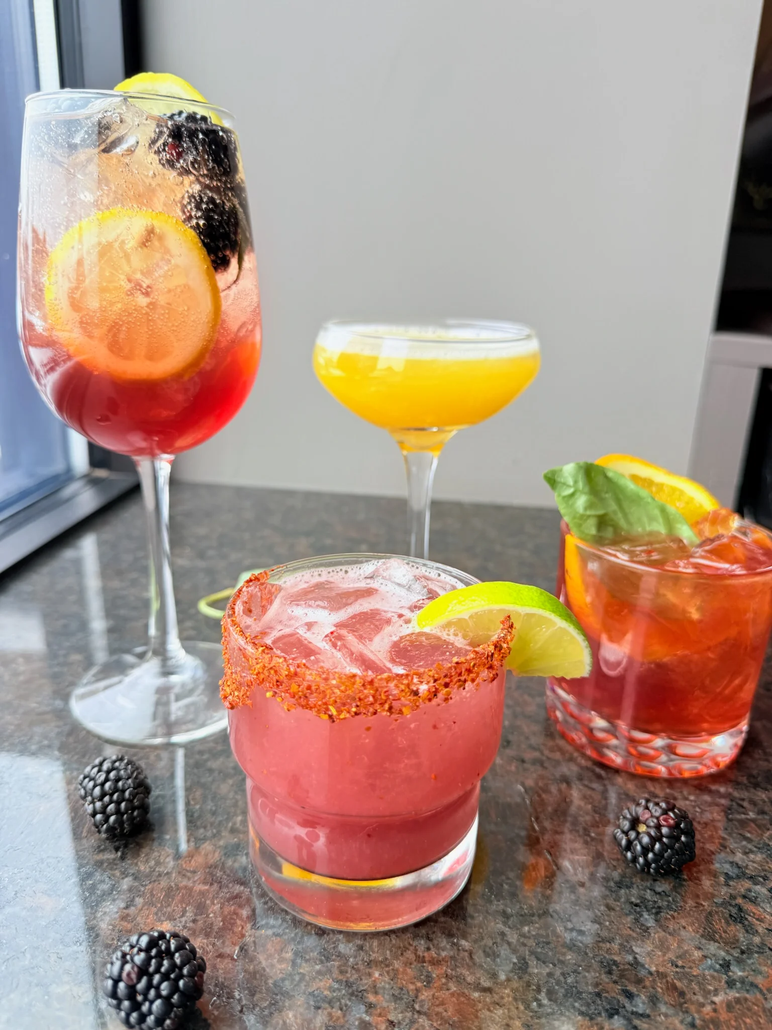 Colorful cocktails on a bar counter with fresh fruit garnishes