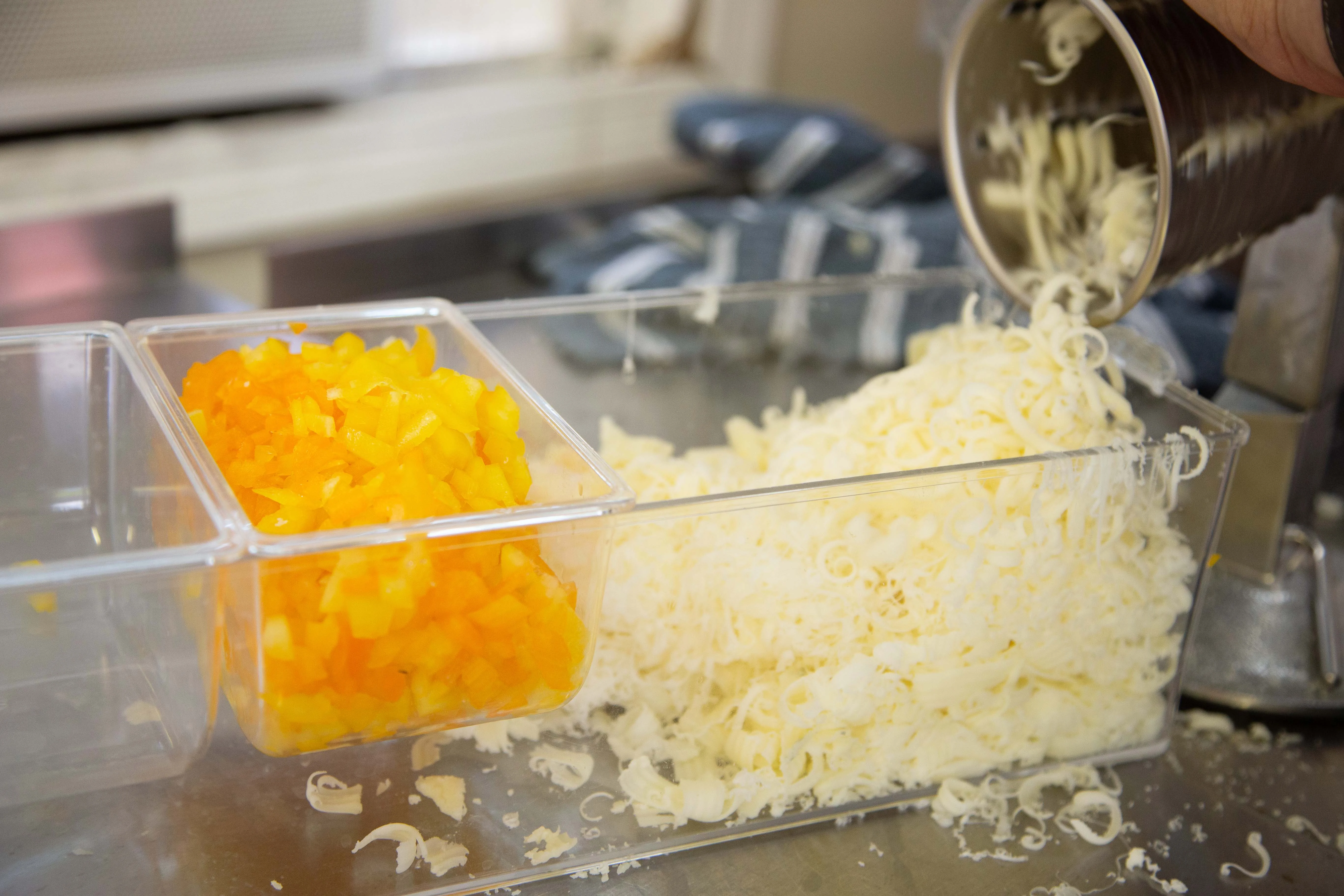 Freshly grated cheese and diced peppers for Mexican cuisine
