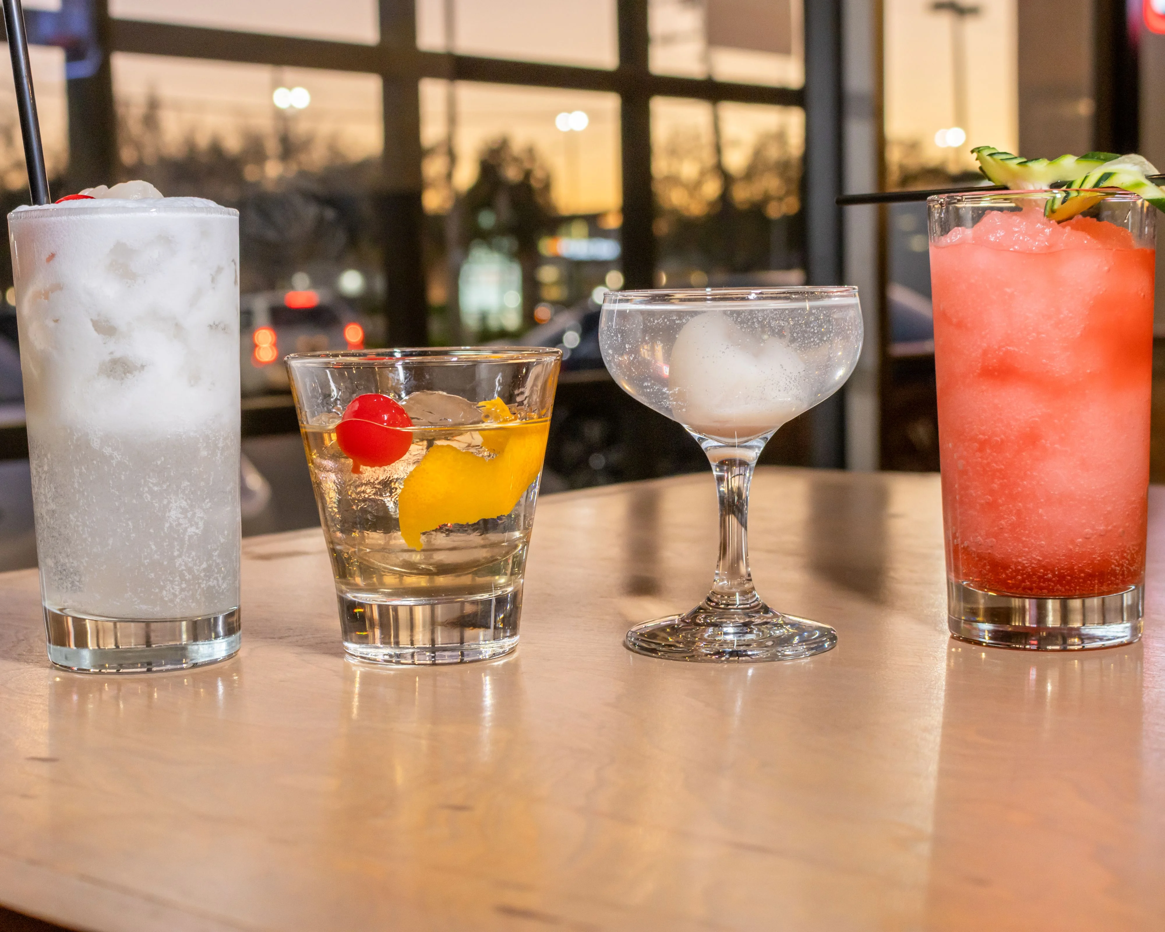 Variety of colorful cocktails on a wooden table