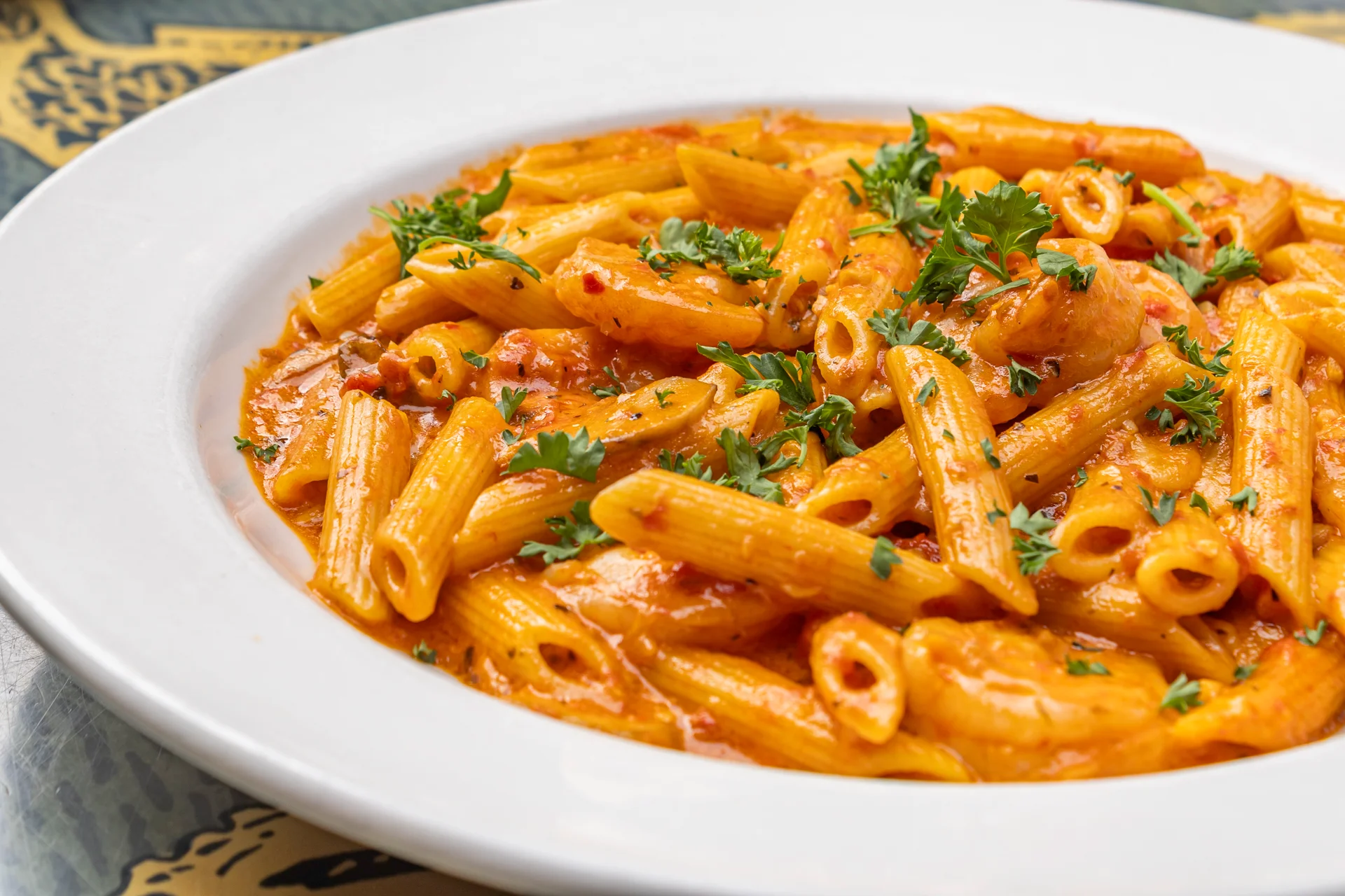 Italian penne pasta in creamy tomato sauce with parsley