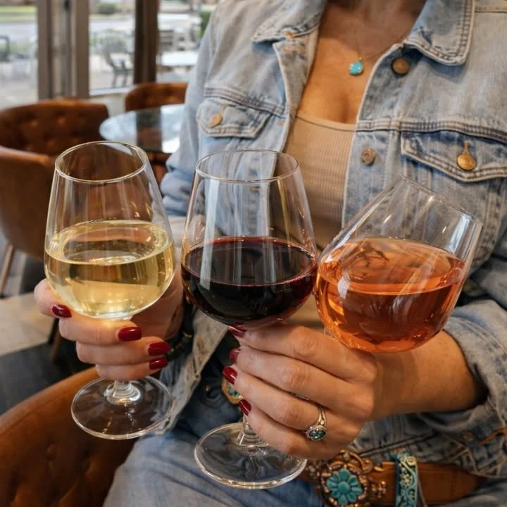 Three wine glasses featuring white, red, and rosé wines
