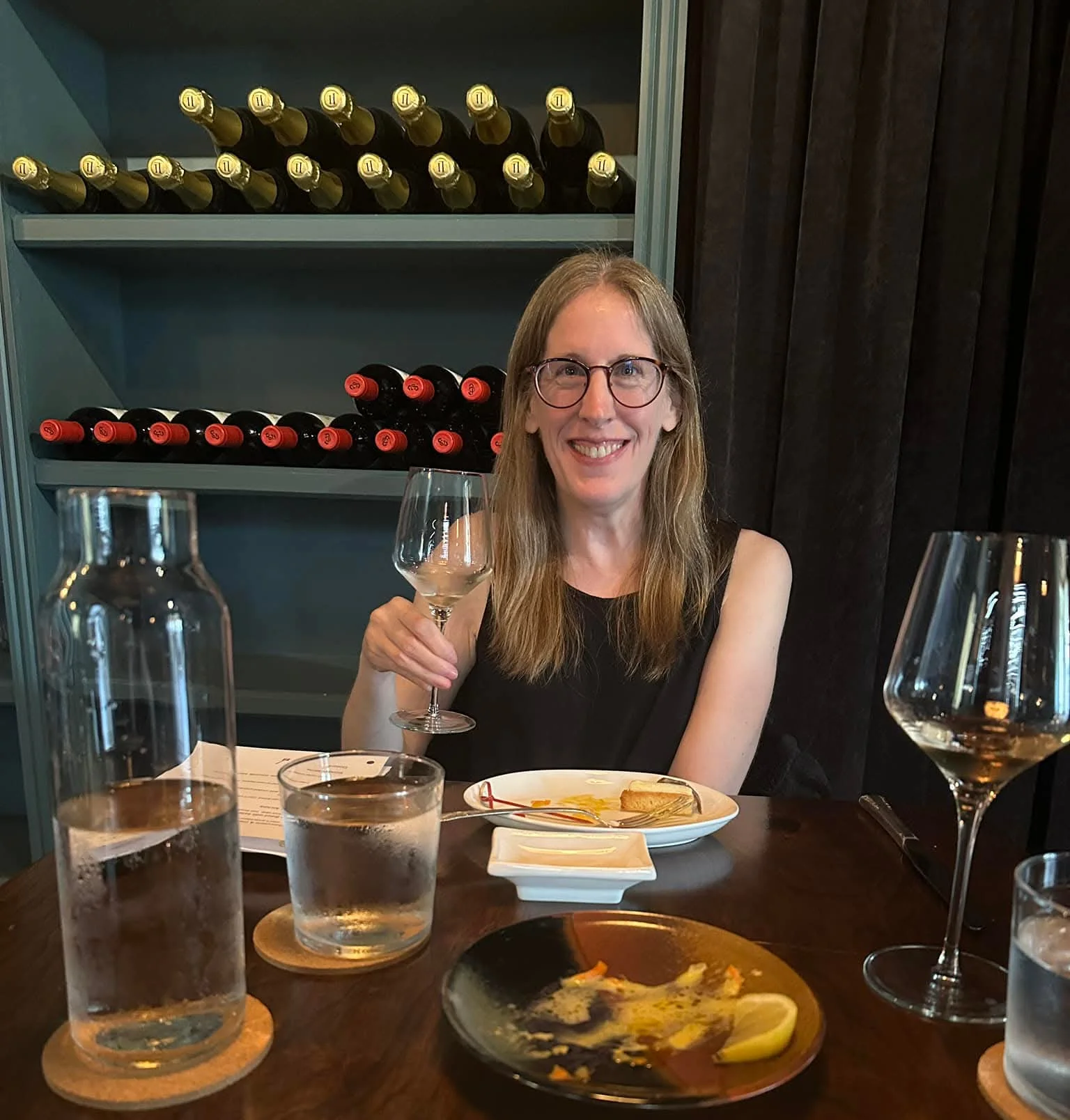 Diner enjoying a glass of wine in a stylish restaurant setting