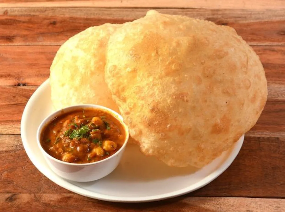 Puffed Indian puris served with chickpea curry