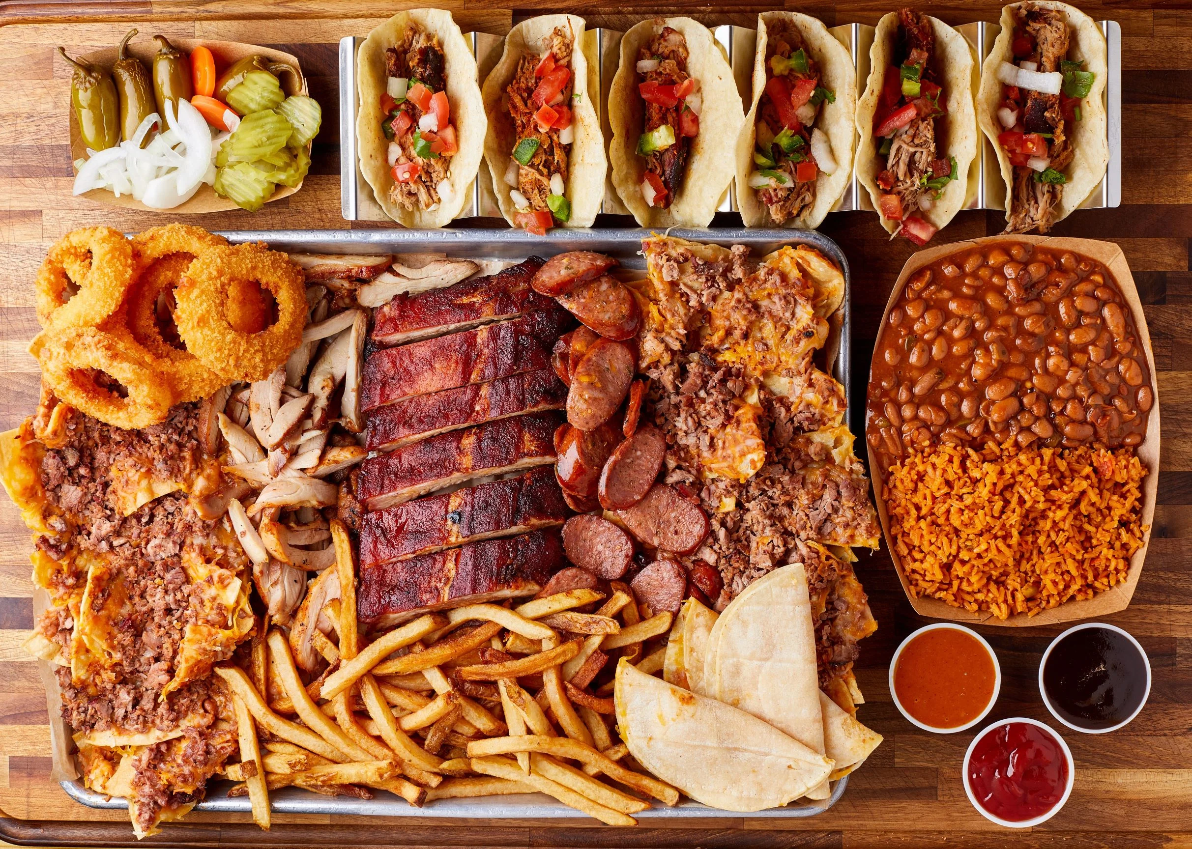 Platter of Texas-style barbecue with tacos and sides