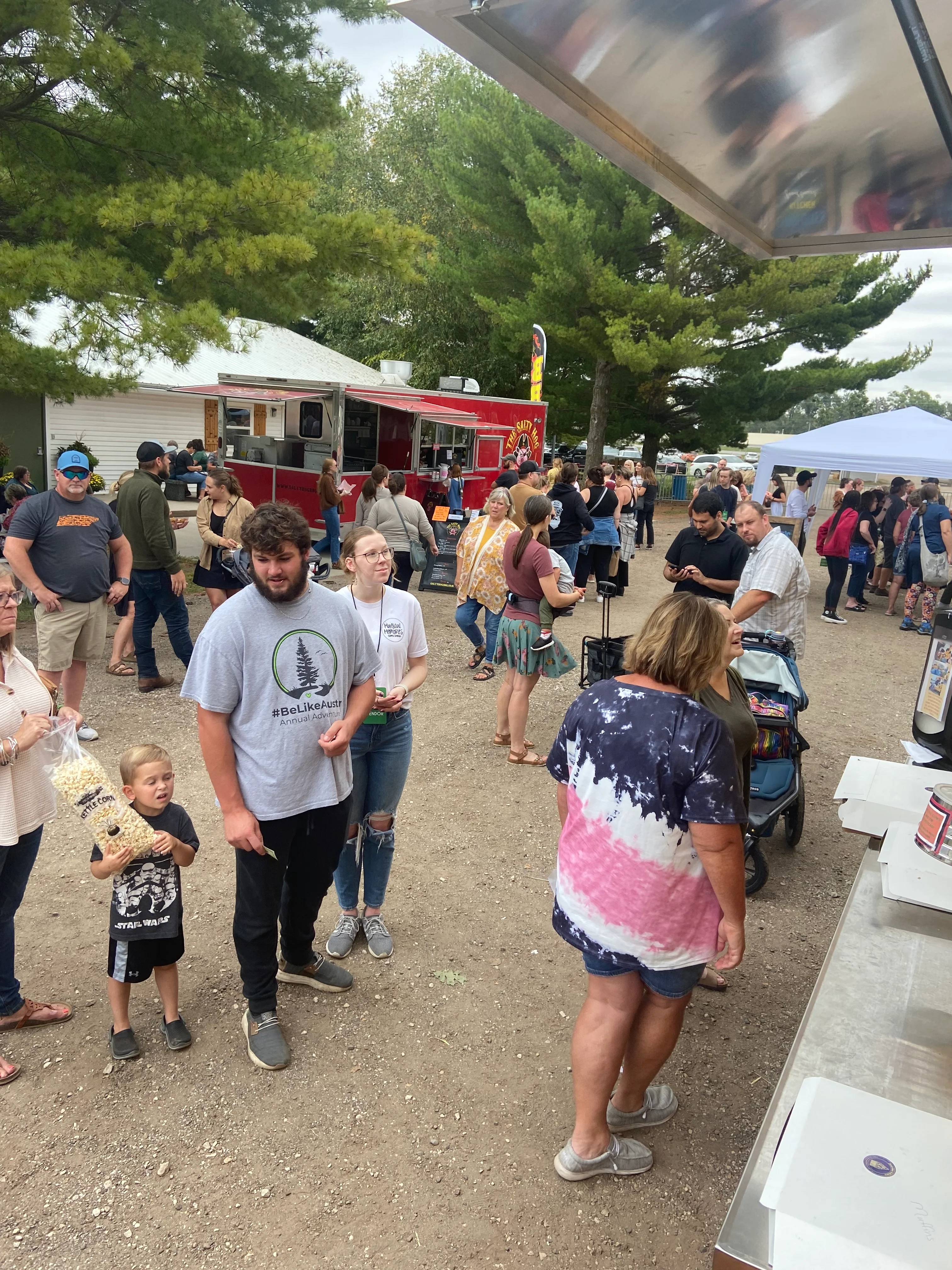 Crowd enjoying food trucks at a lively outdoor festival