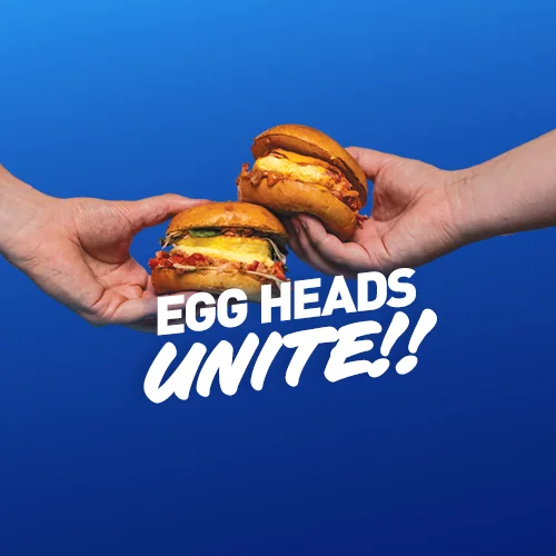 Two breakfast sandwiches featuring eggs and toppings
