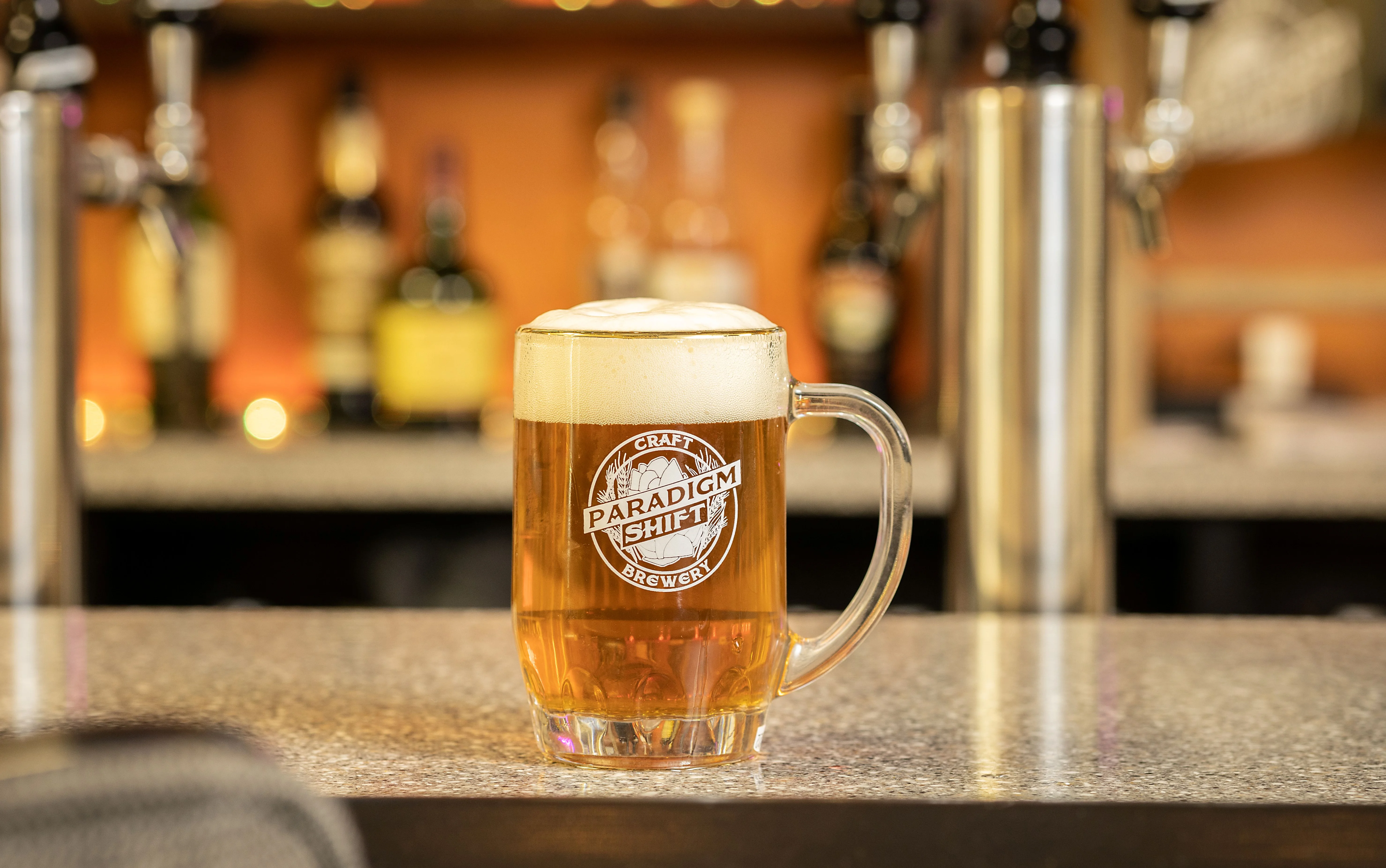 Craft beer in a glass mug at a bar counter