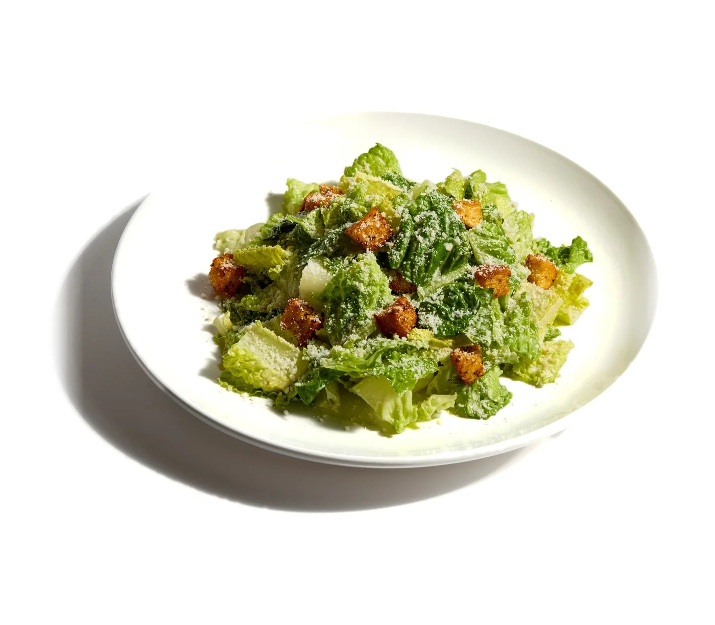 Caesar salad with croutons and shaved Parmesan