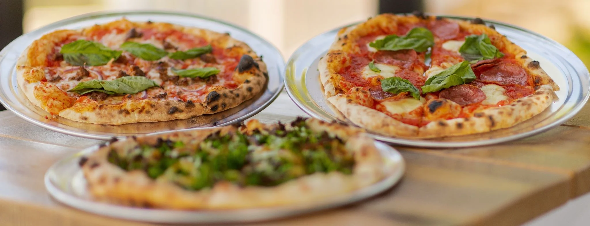 Three delicious pizzas including Margherita and pepperoni varieties