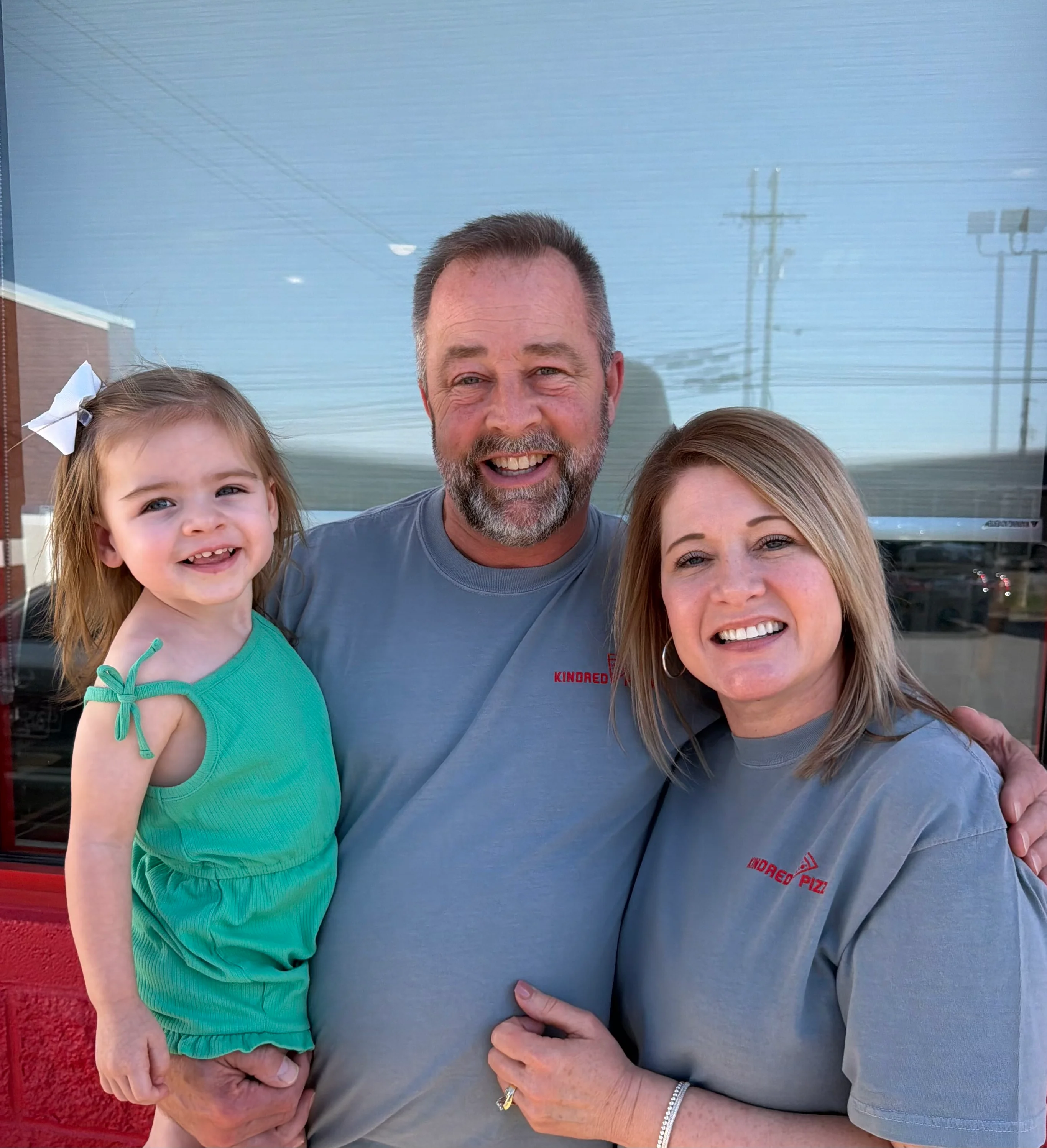 Family portrait outside a restaurant with smiles and warm atmosphere