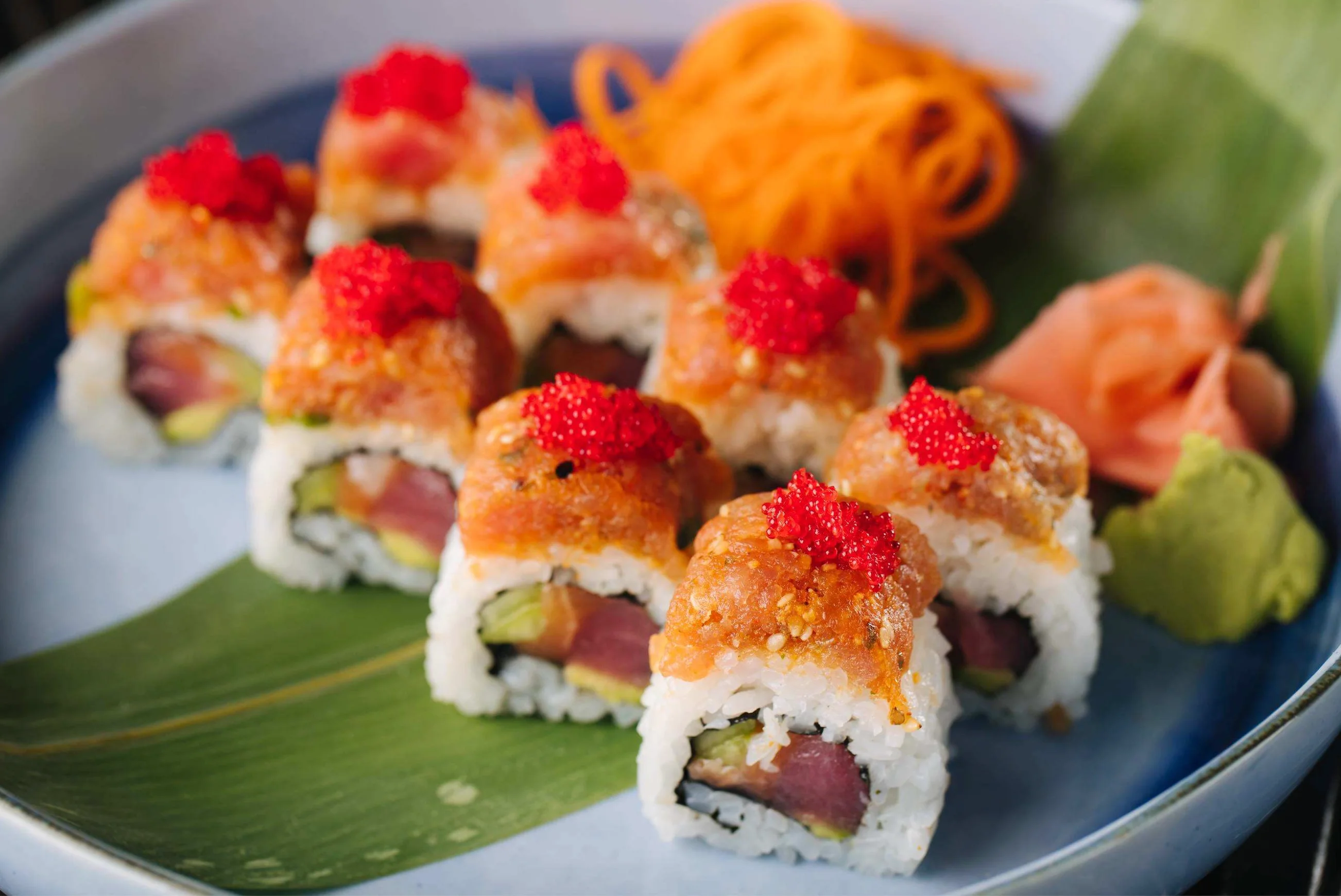 Japanese sushi rolls topped with spicy tuna and fish roe