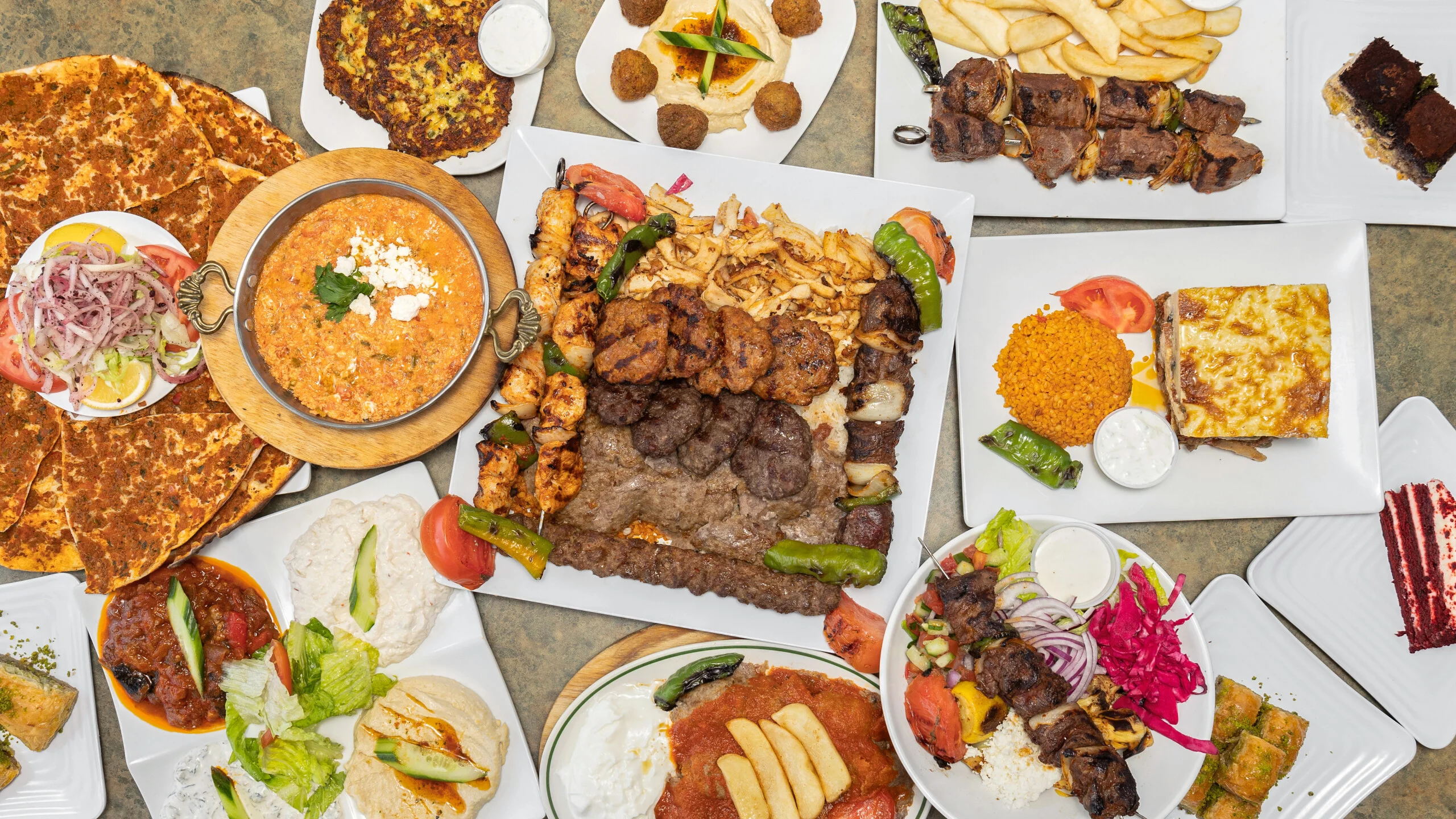 Mixed grill platter featuring Mediterranean kebabs and dips