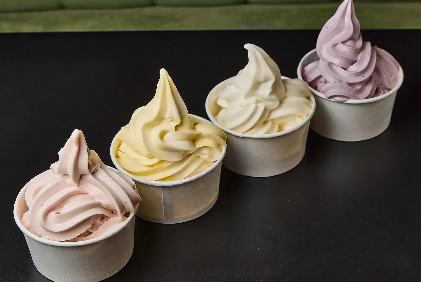 Assorted soft serve ice cream cups in pastel colors