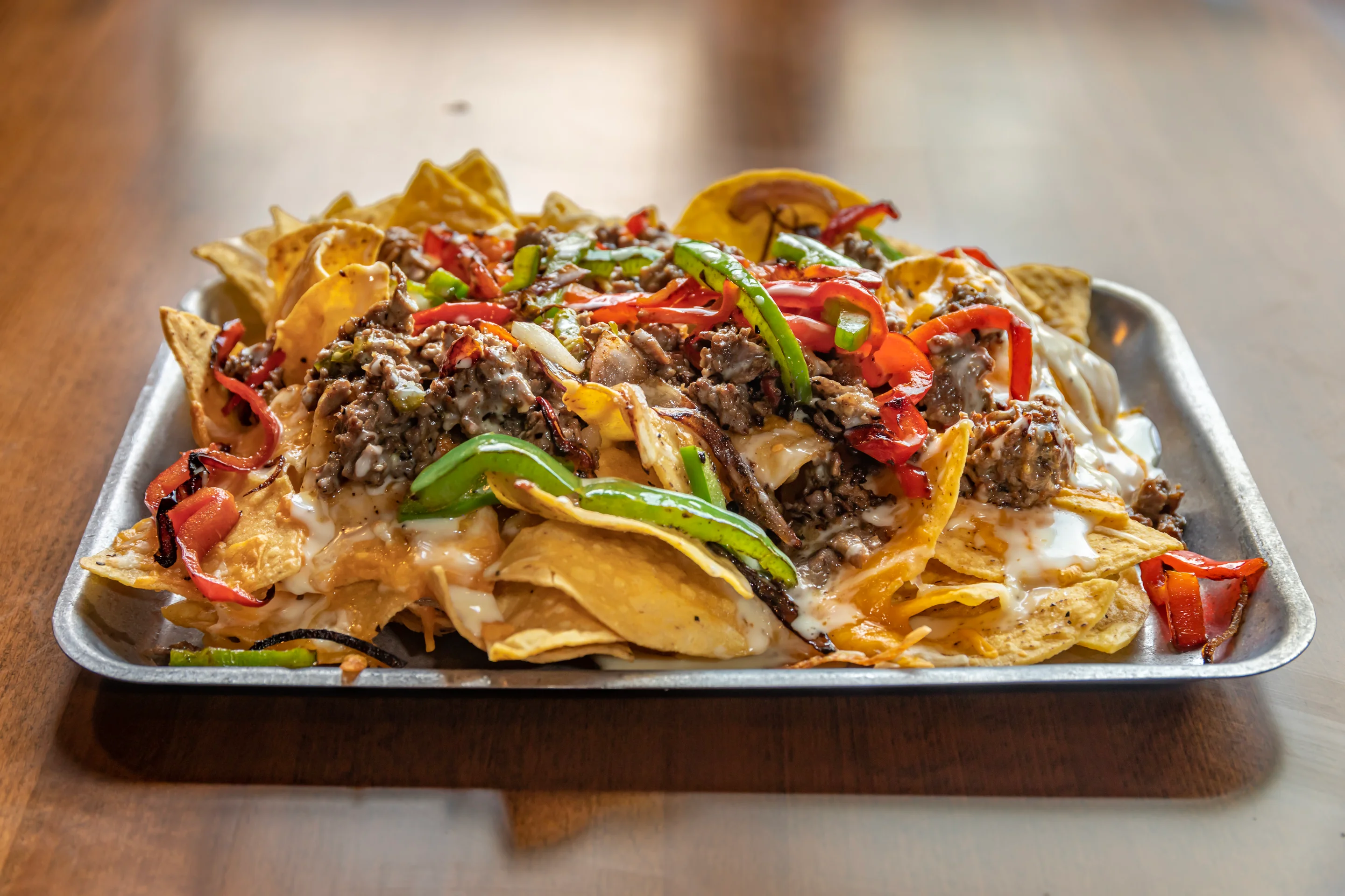 Loaded nachos topped with beef and fresh vegetables