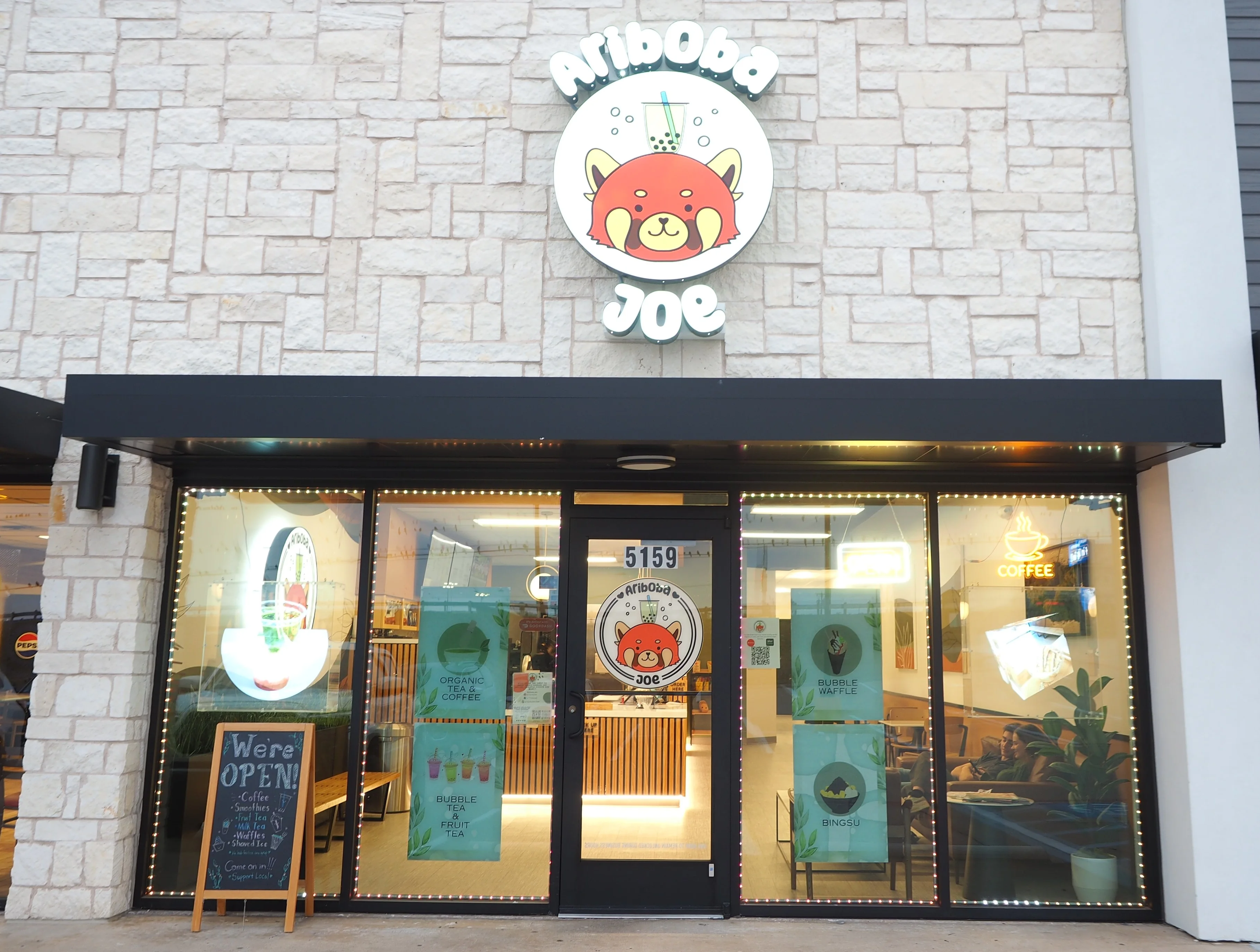 Boba tea shop exterior with vibrant signage