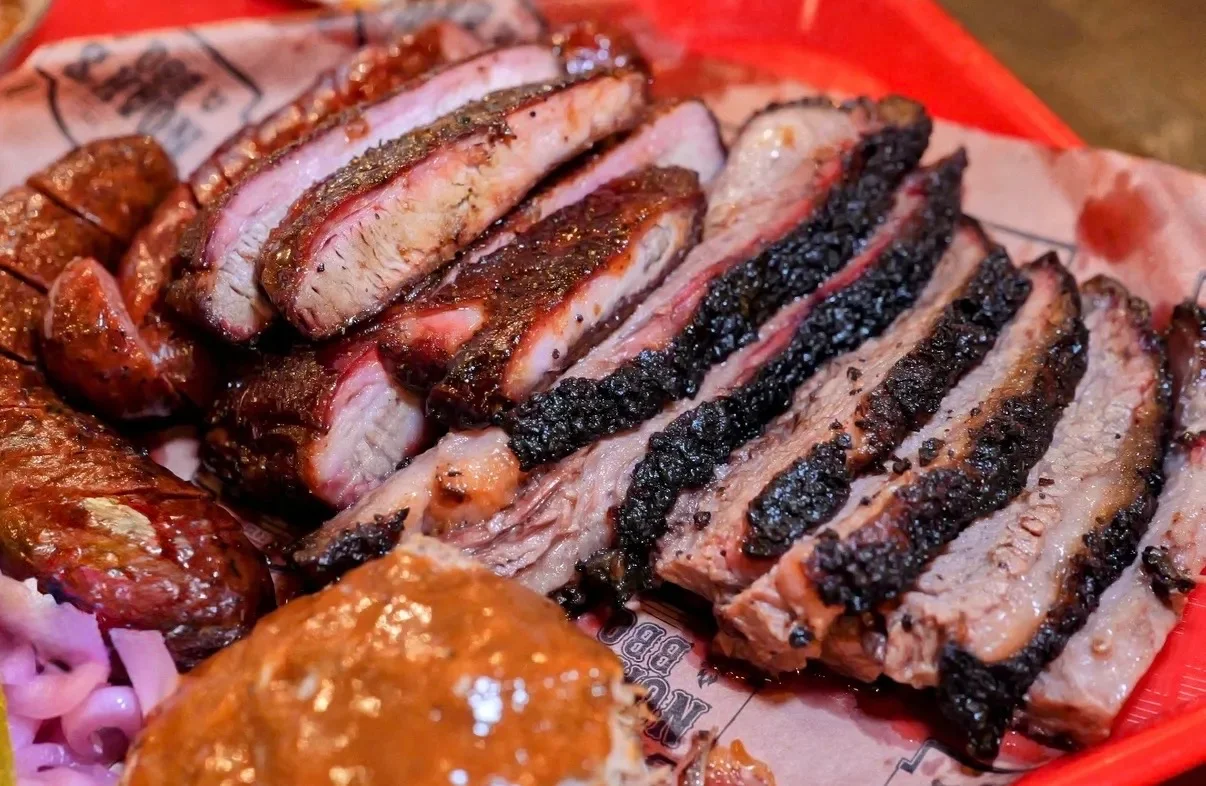 Texas-style smoked brisket platter with sausage