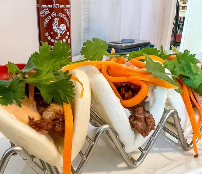 Vietnamese banh bao with grilled meat and fresh herbs