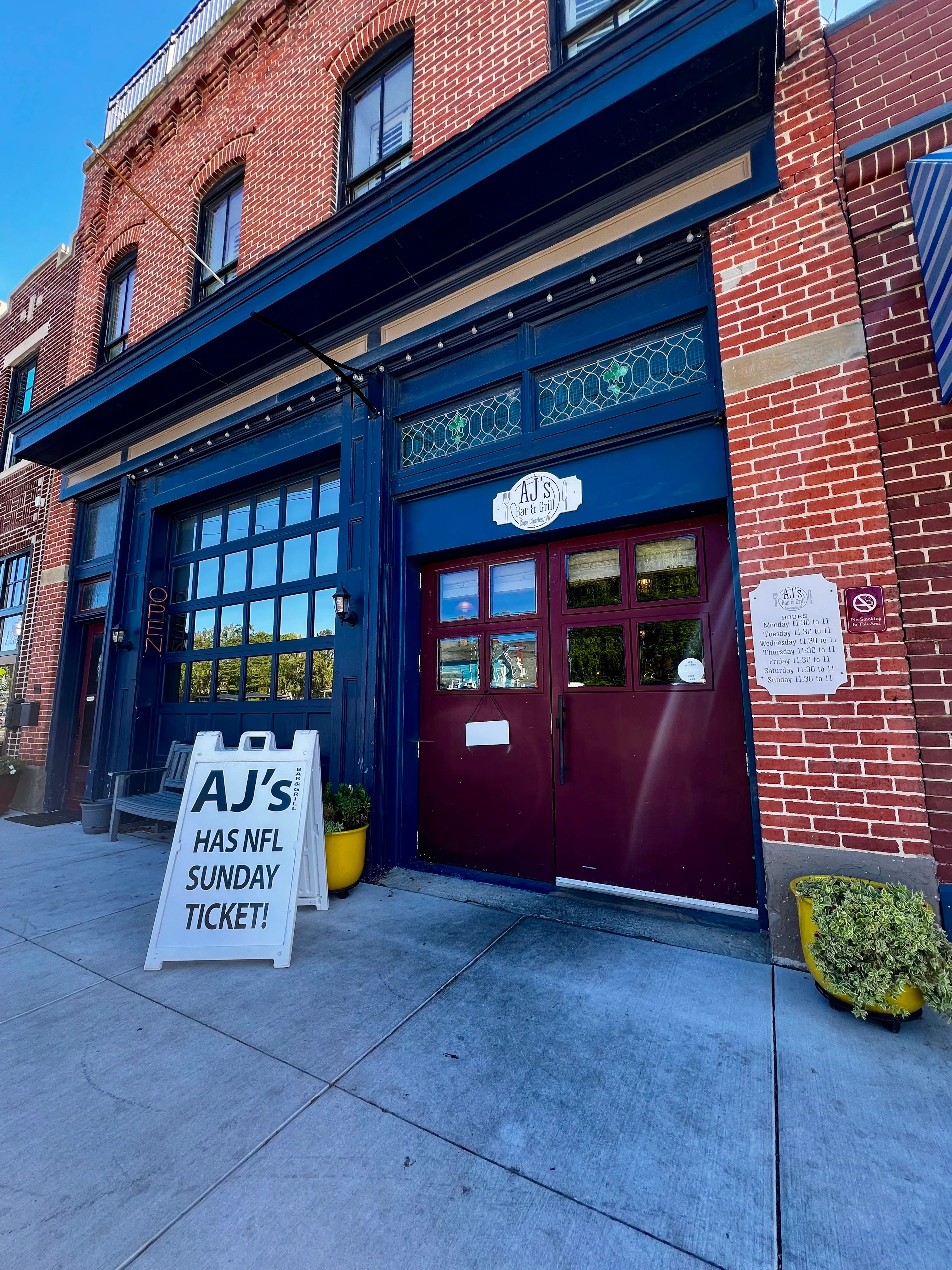 Exterior view of AJ's Bar & Grill with NFL Sunday Ticket sign