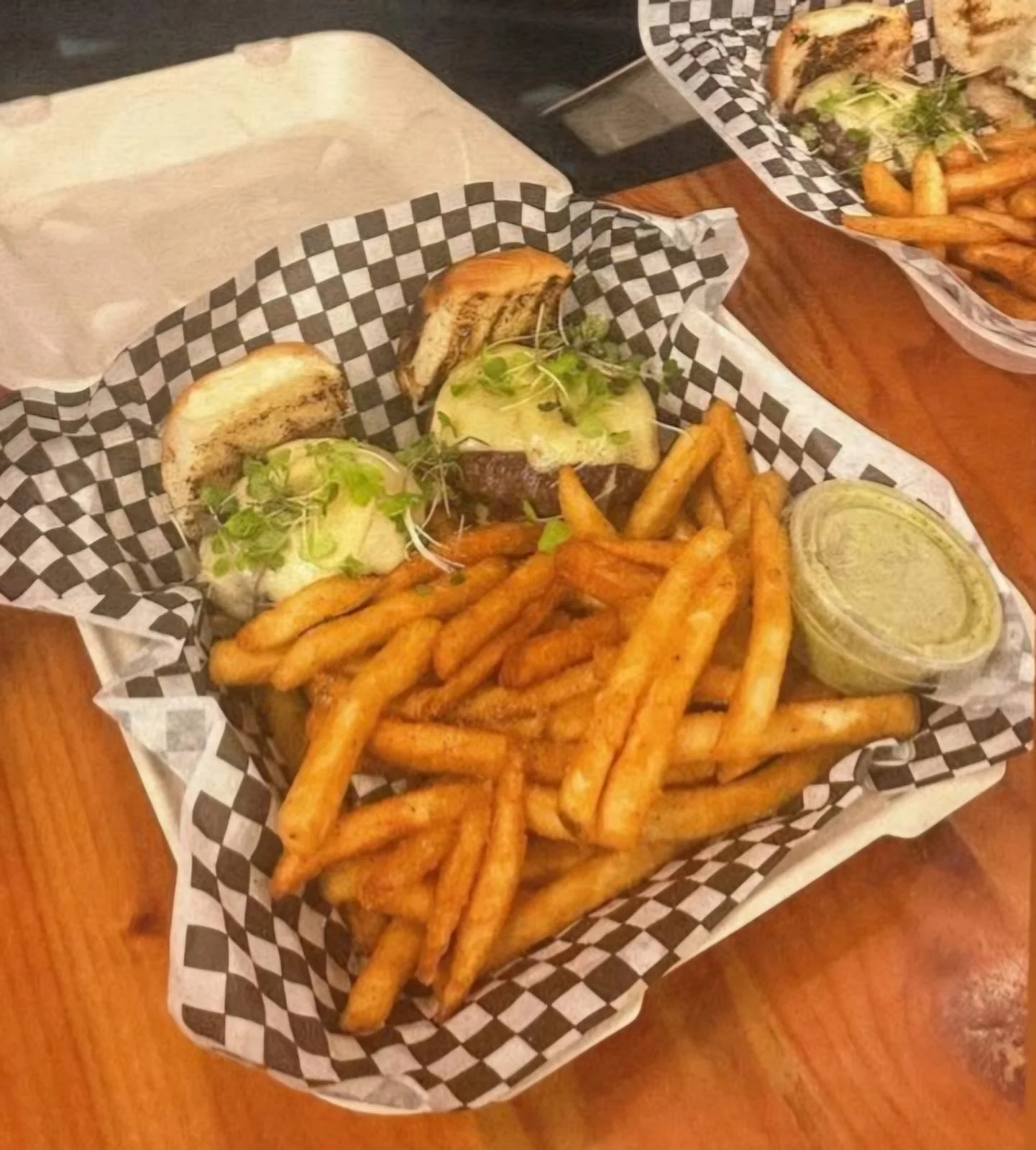 Juicy cheeseburgers with fries in a casual dining setting