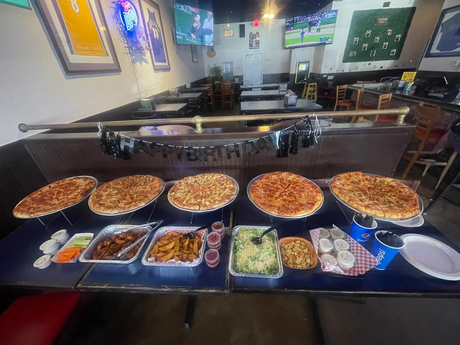Variety of pizzas and appetizers for a birthday celebration