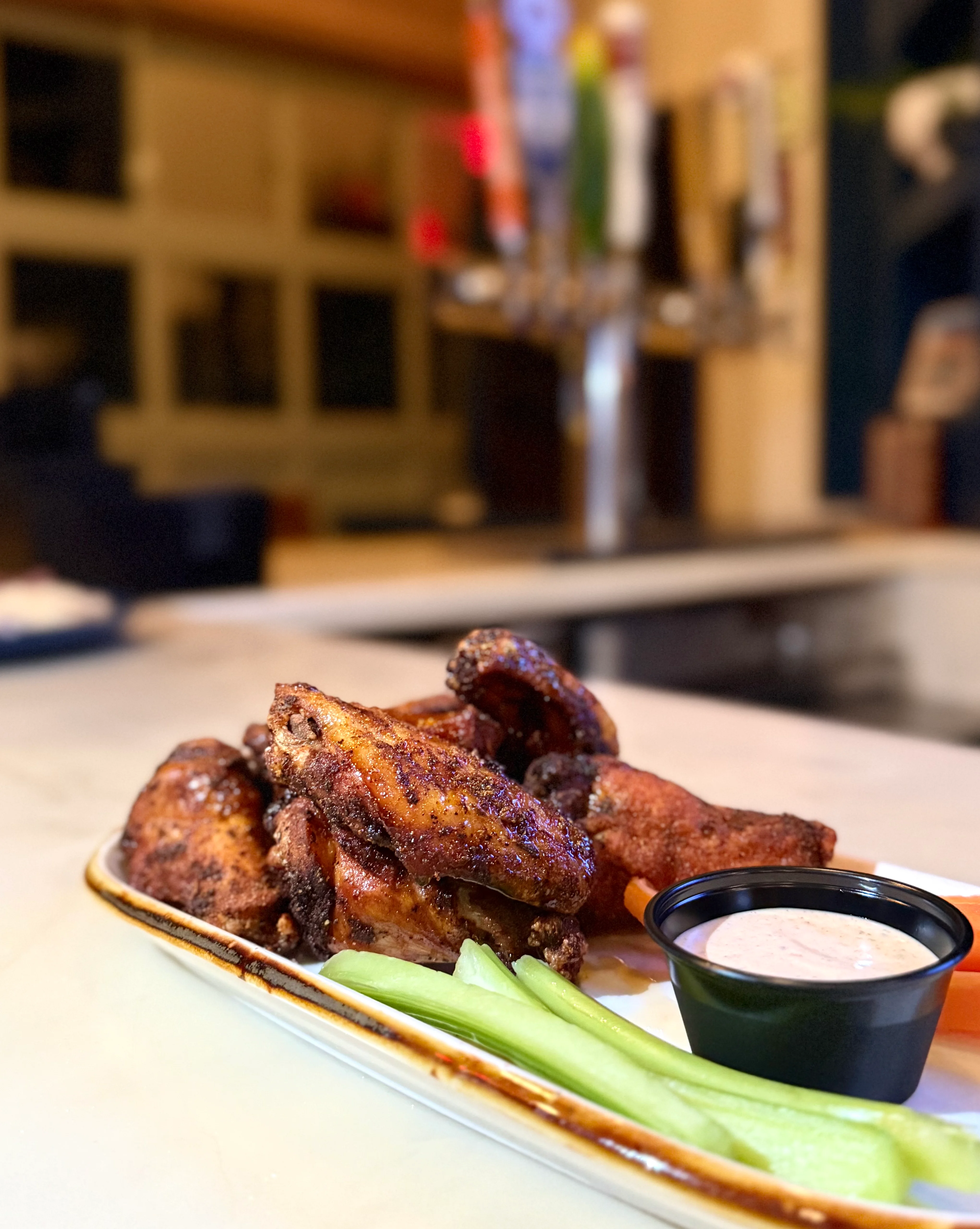 Crispy buffalo chicken wings with celery and ranch dressing