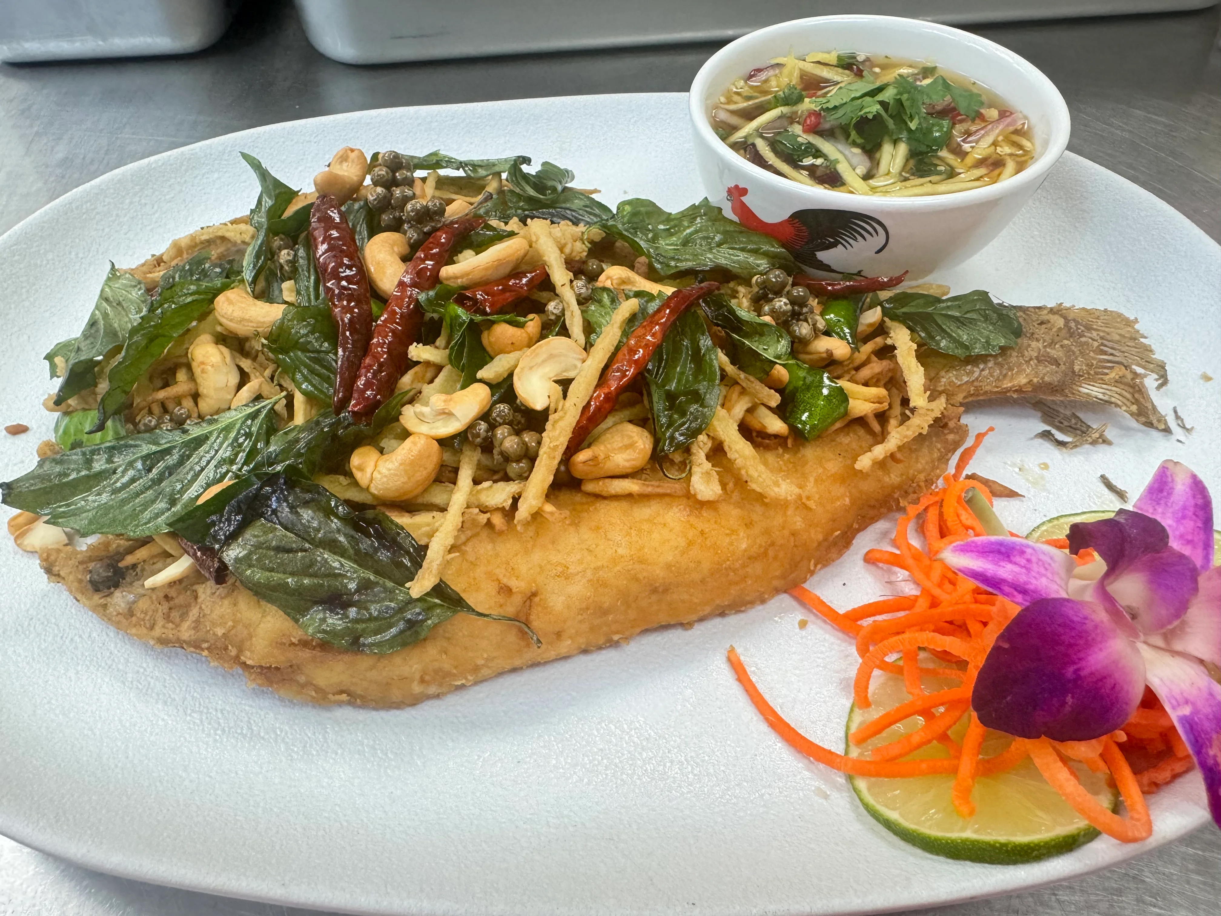 Crispy Thai fish topped with herbs and spices