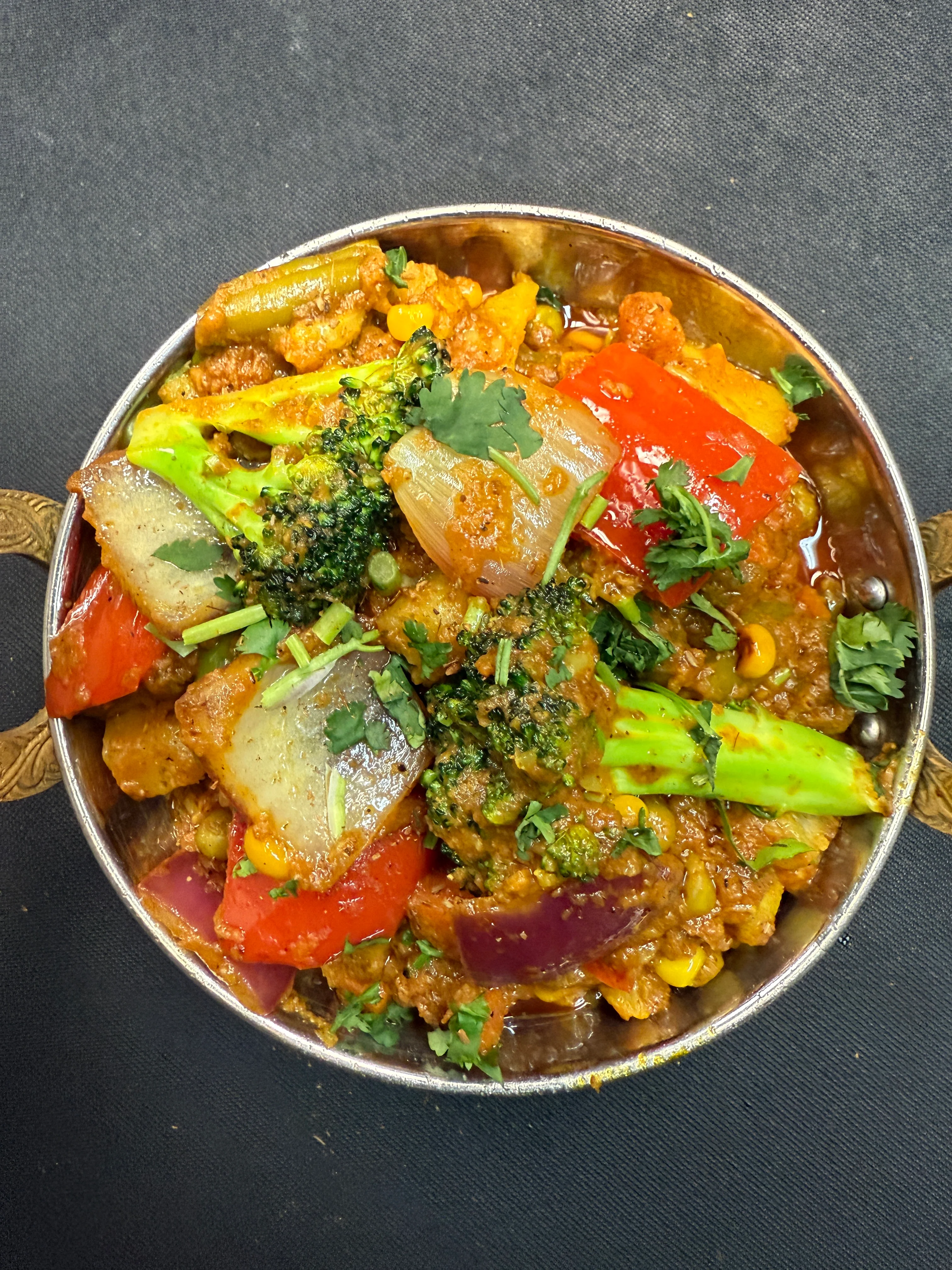 Indian mixed vegetable curry in a traditional serving dish