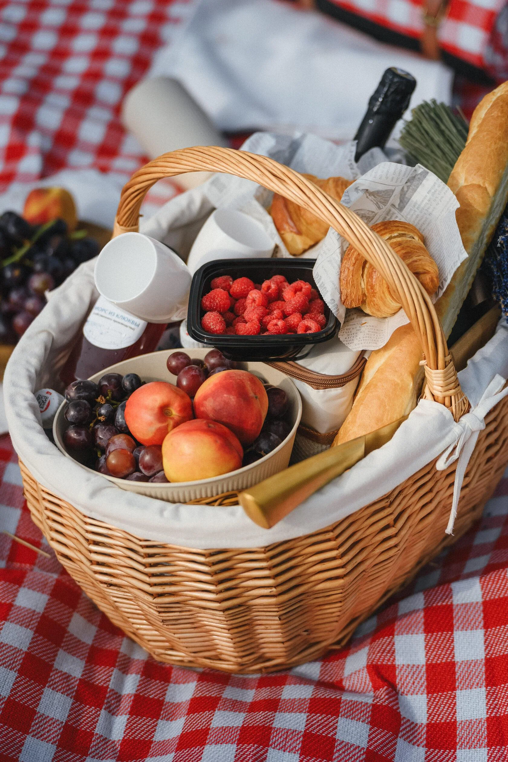 Picnic basket filled with fresh fruits and pastries