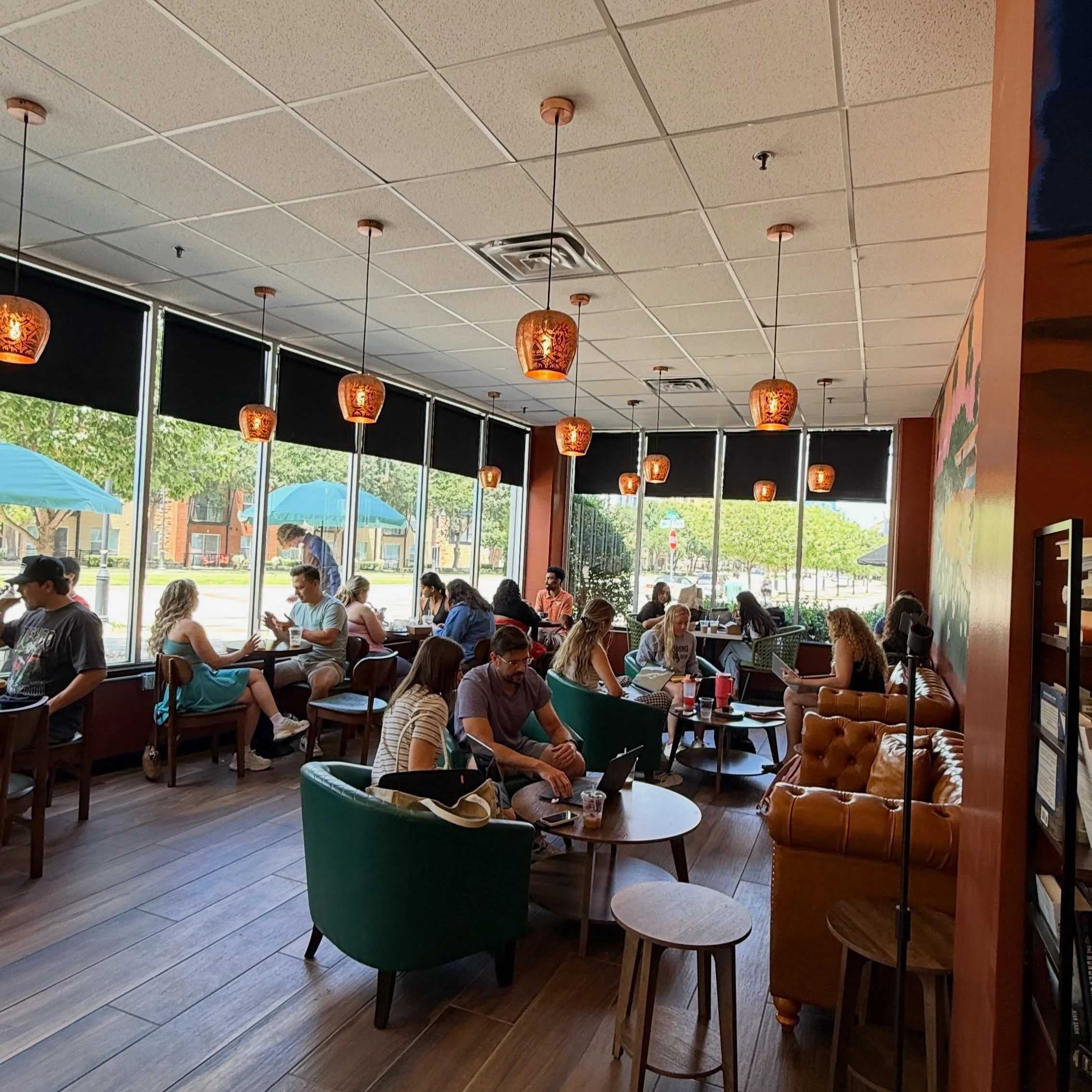 Cozy café interior with patrons enjoying drinks and conversation