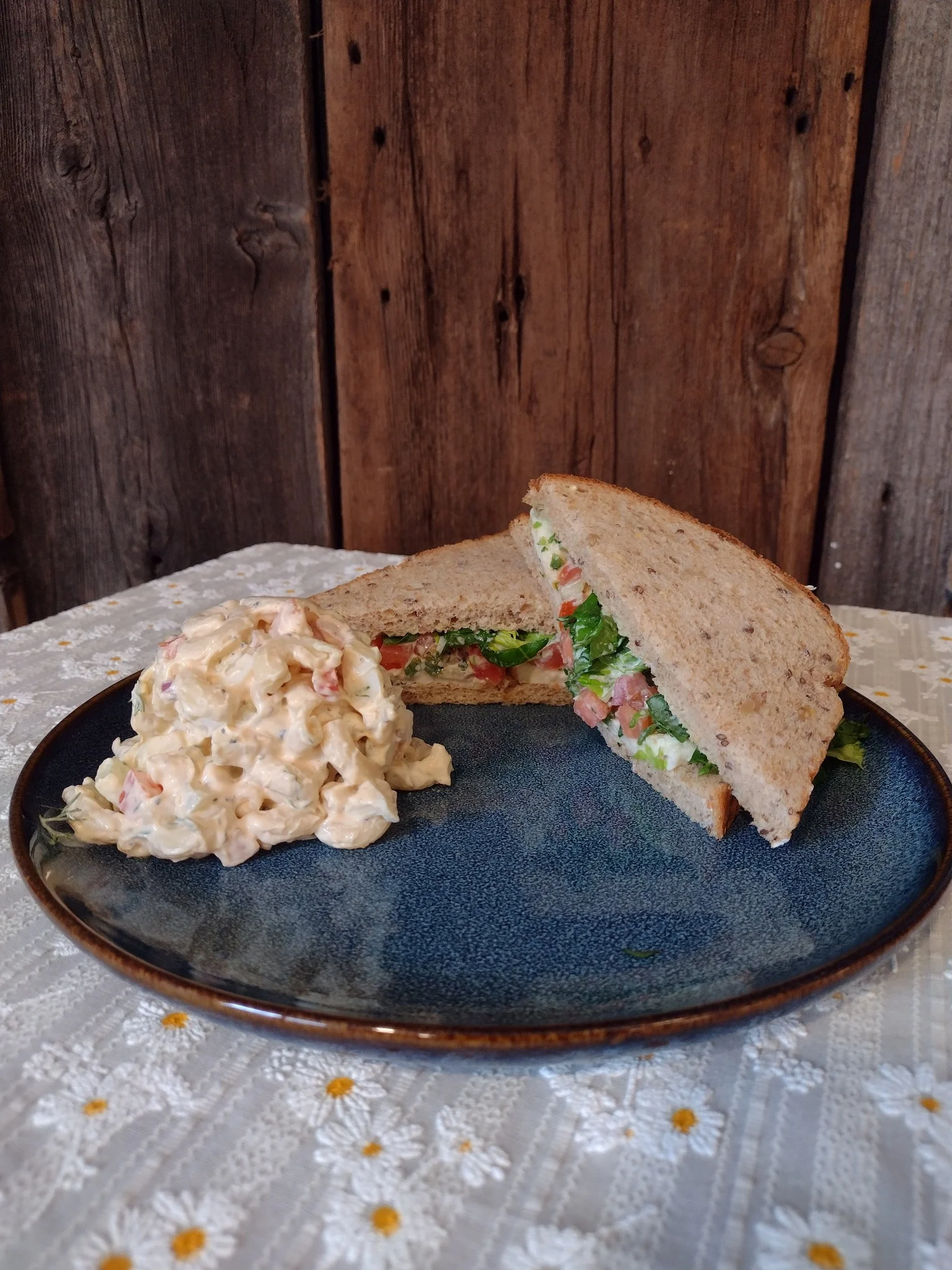 Whole grain sandwich with salad and creamy side dish