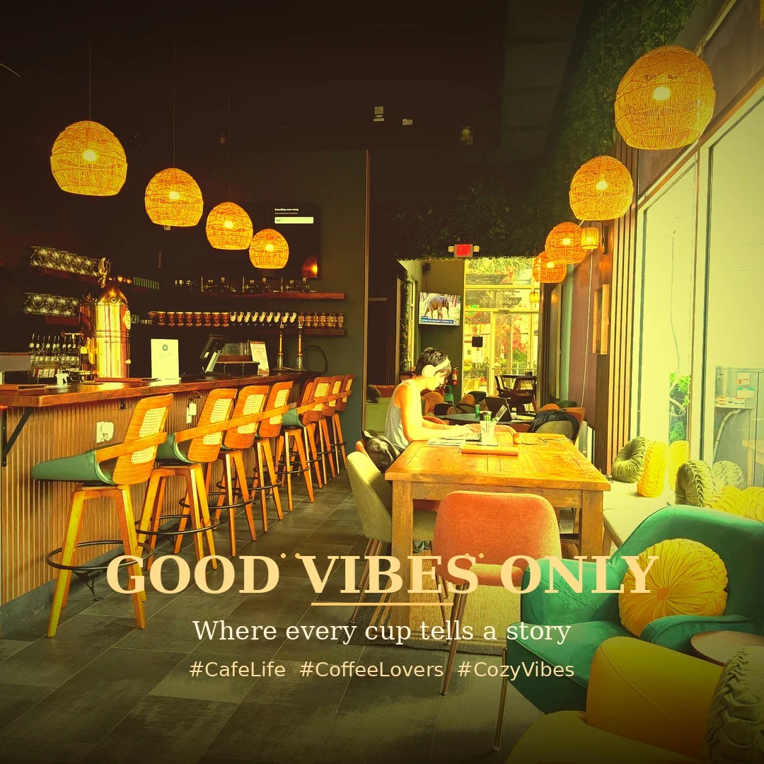 An inviting cafe interior featuring wooden bar stools, a long bar, and cozy seating areas. Warm pendant lights hang overhead, creating a relaxed atmosphere.