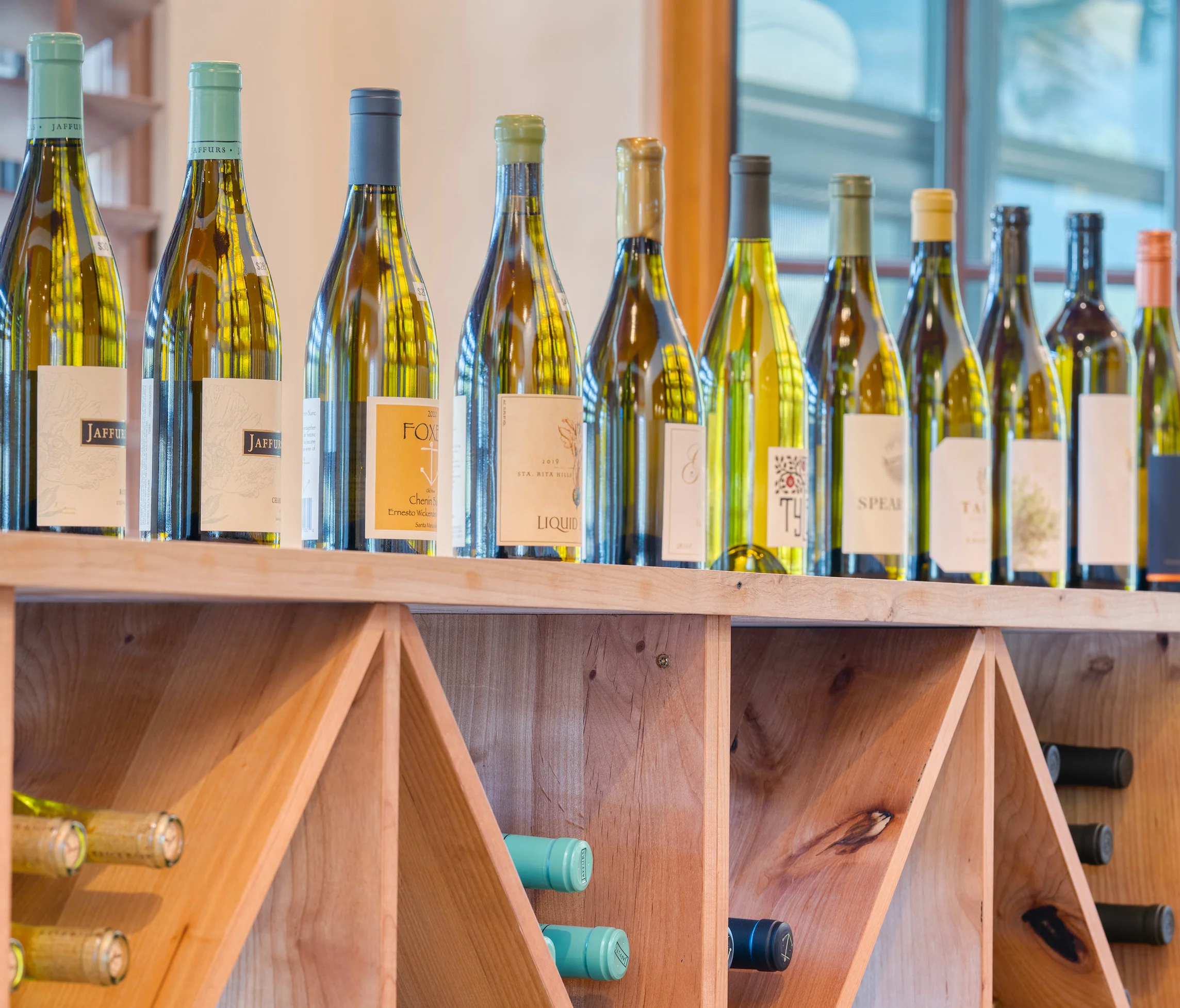 Selection of fine wines displayed on a wooden rack