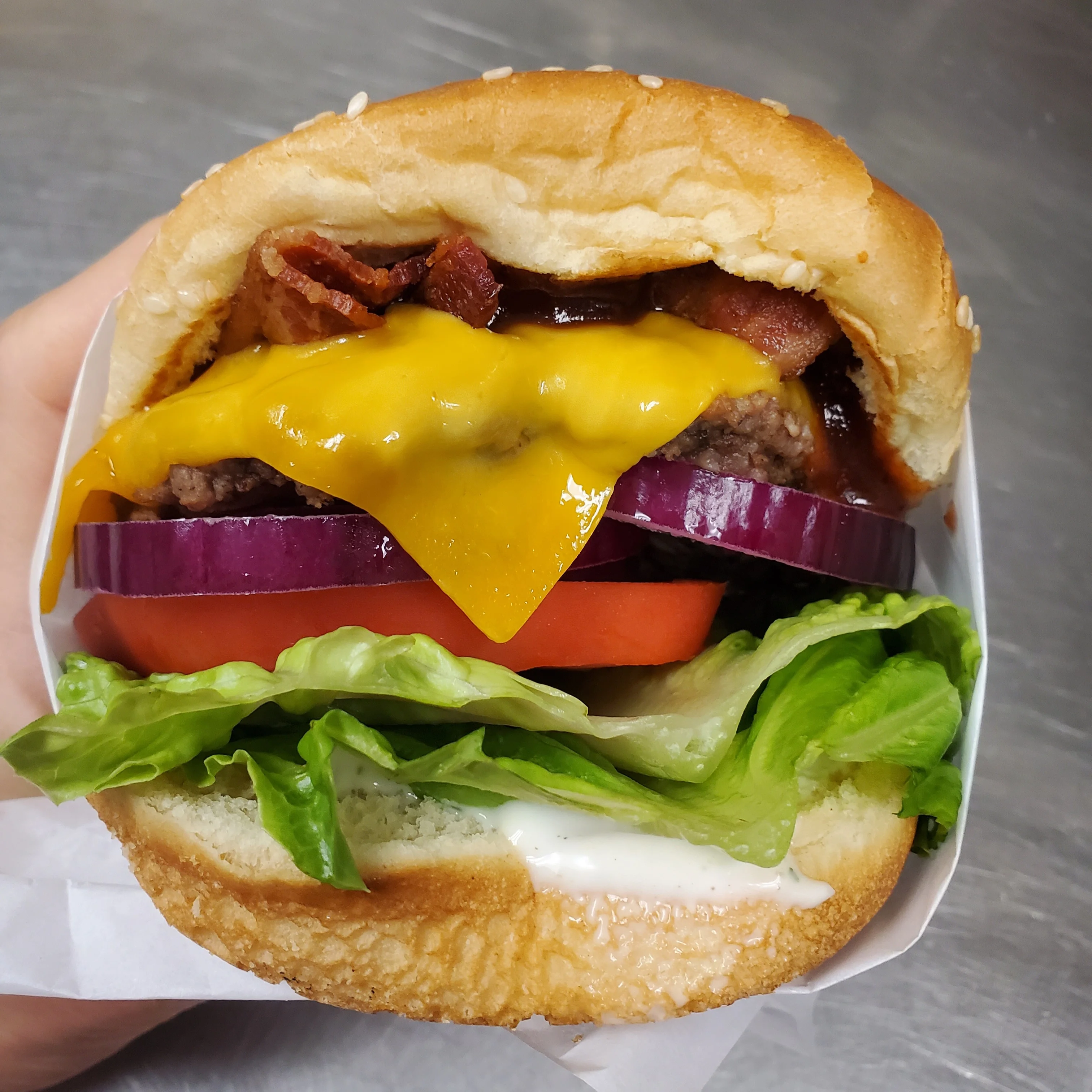 Juicy cheeseburger with bacon and fresh toppings