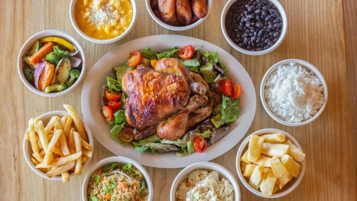 Peruvian pollo a la brasa with sides and salads
