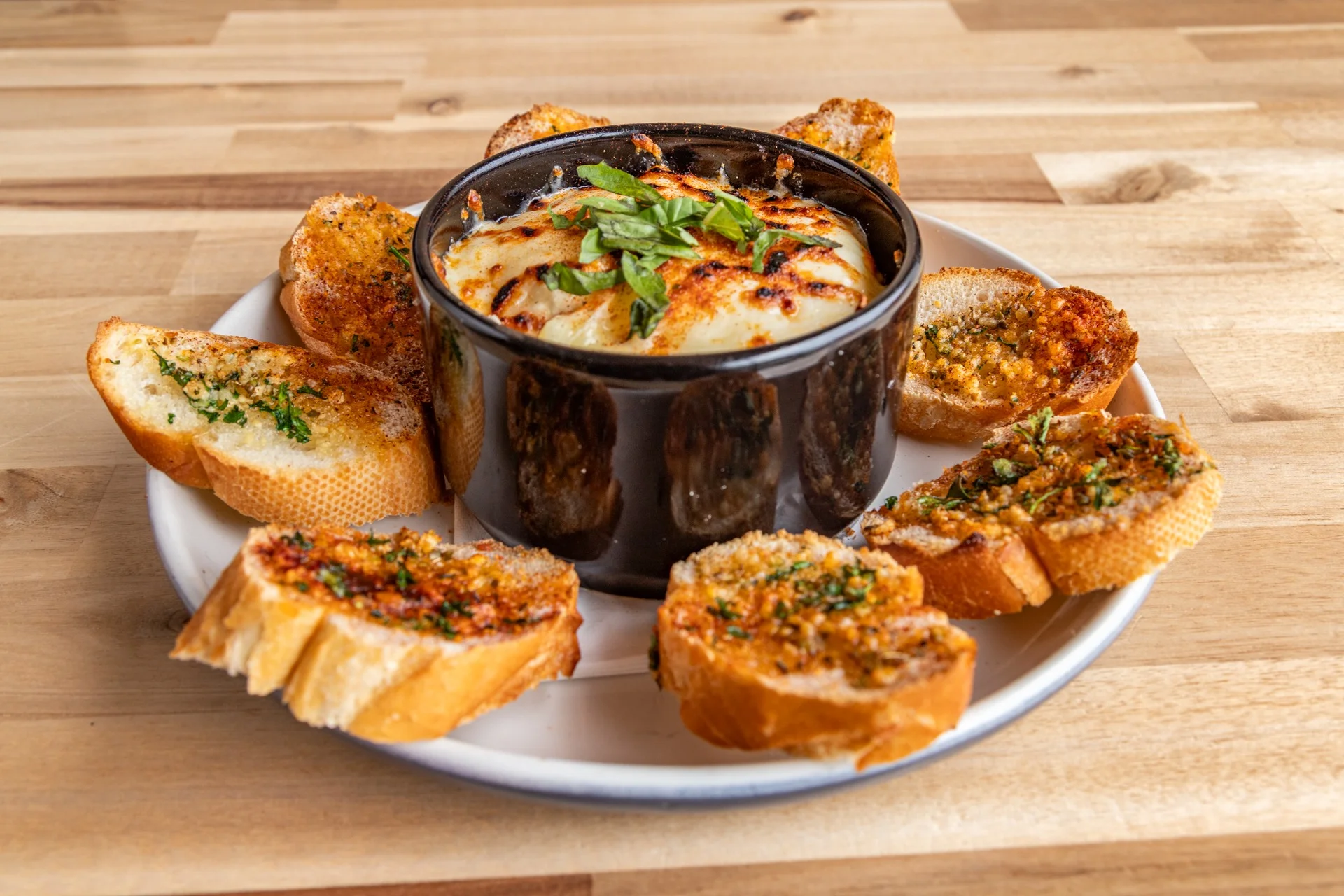 Baked cheese dip served with garlic bread