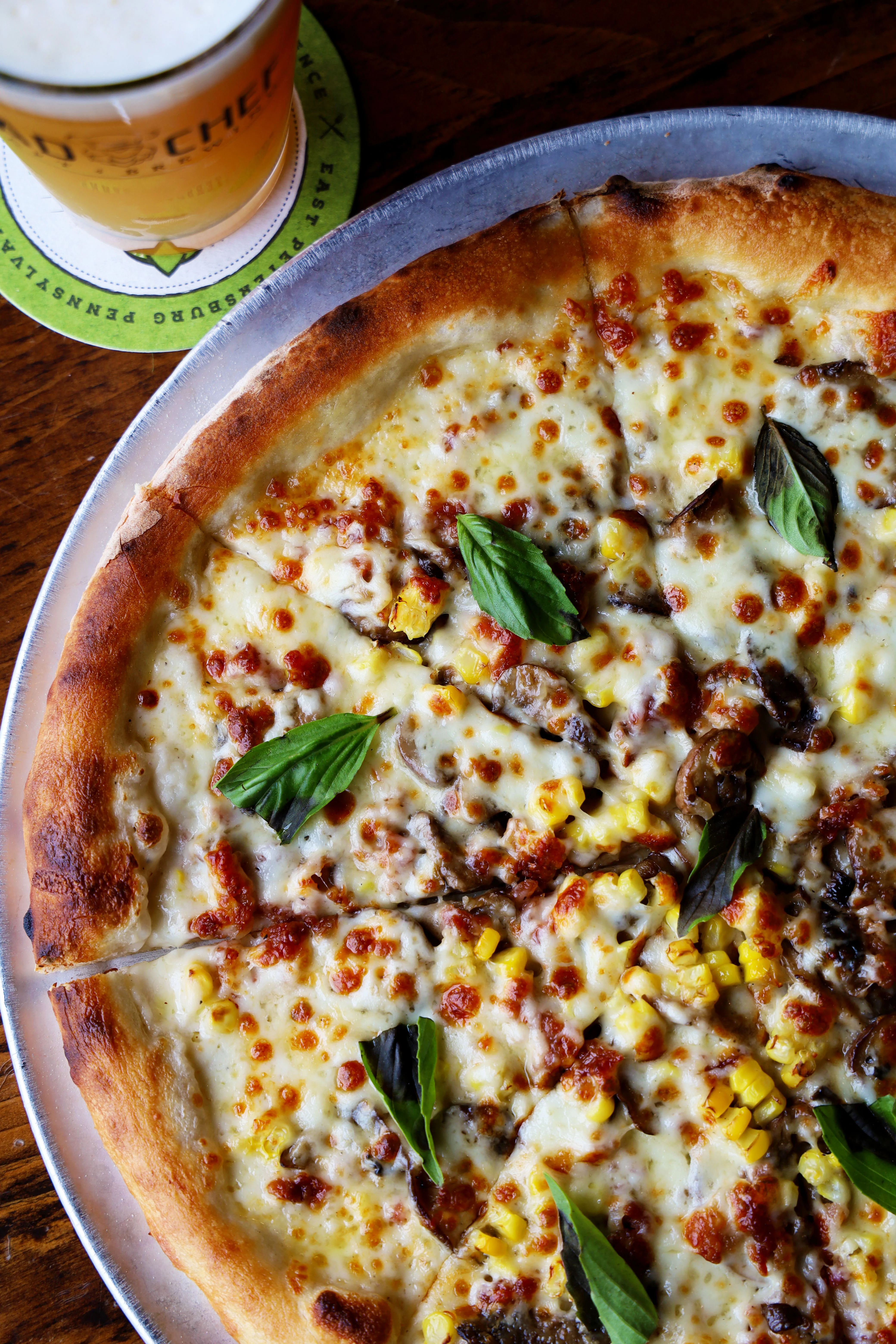 Delicious wood-fired pizza with cheese and basil
