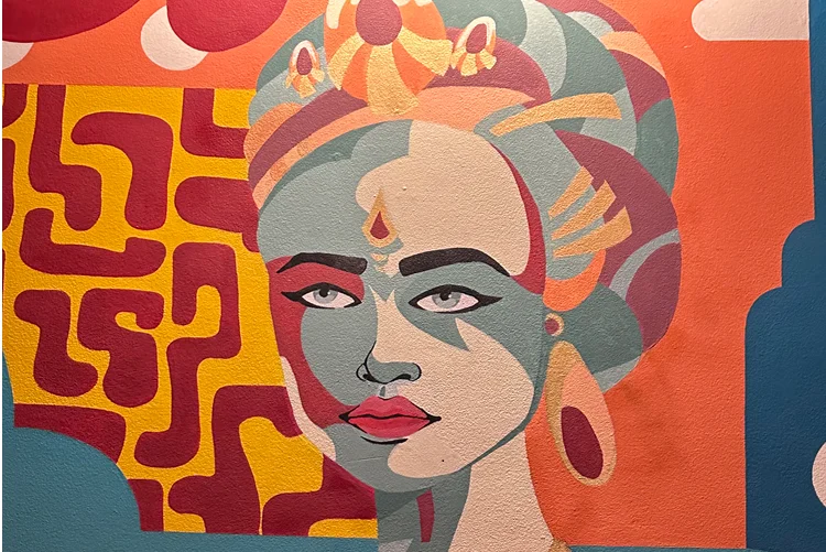Colorful mural of a woman with intricate headdress and bold patterns