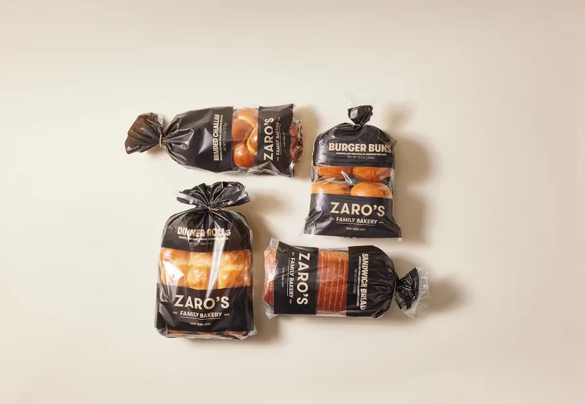 Assorted Zaro's bakery bread products including challah and burger buns