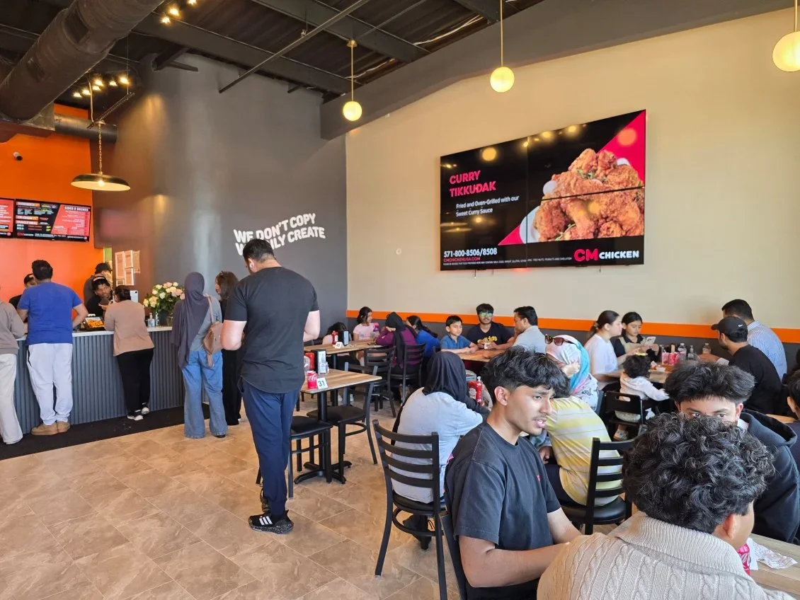 Busy restaurant interior with patrons enjoying Korean fried chicken