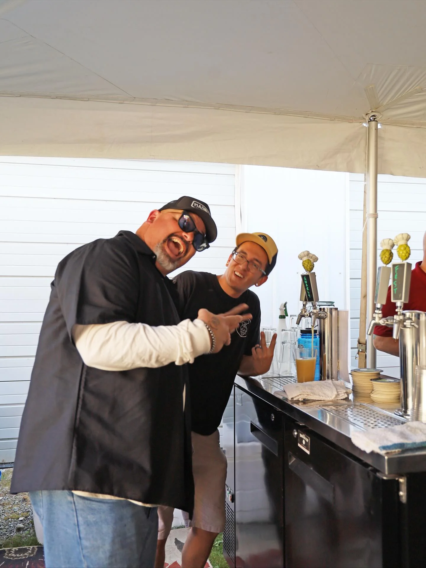 Bartenders enjoying a lively moment at a bar counter