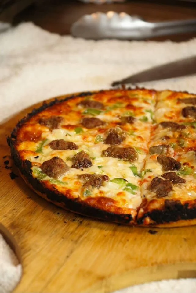 Sicilian-style pizza topped with sausage and green peppers