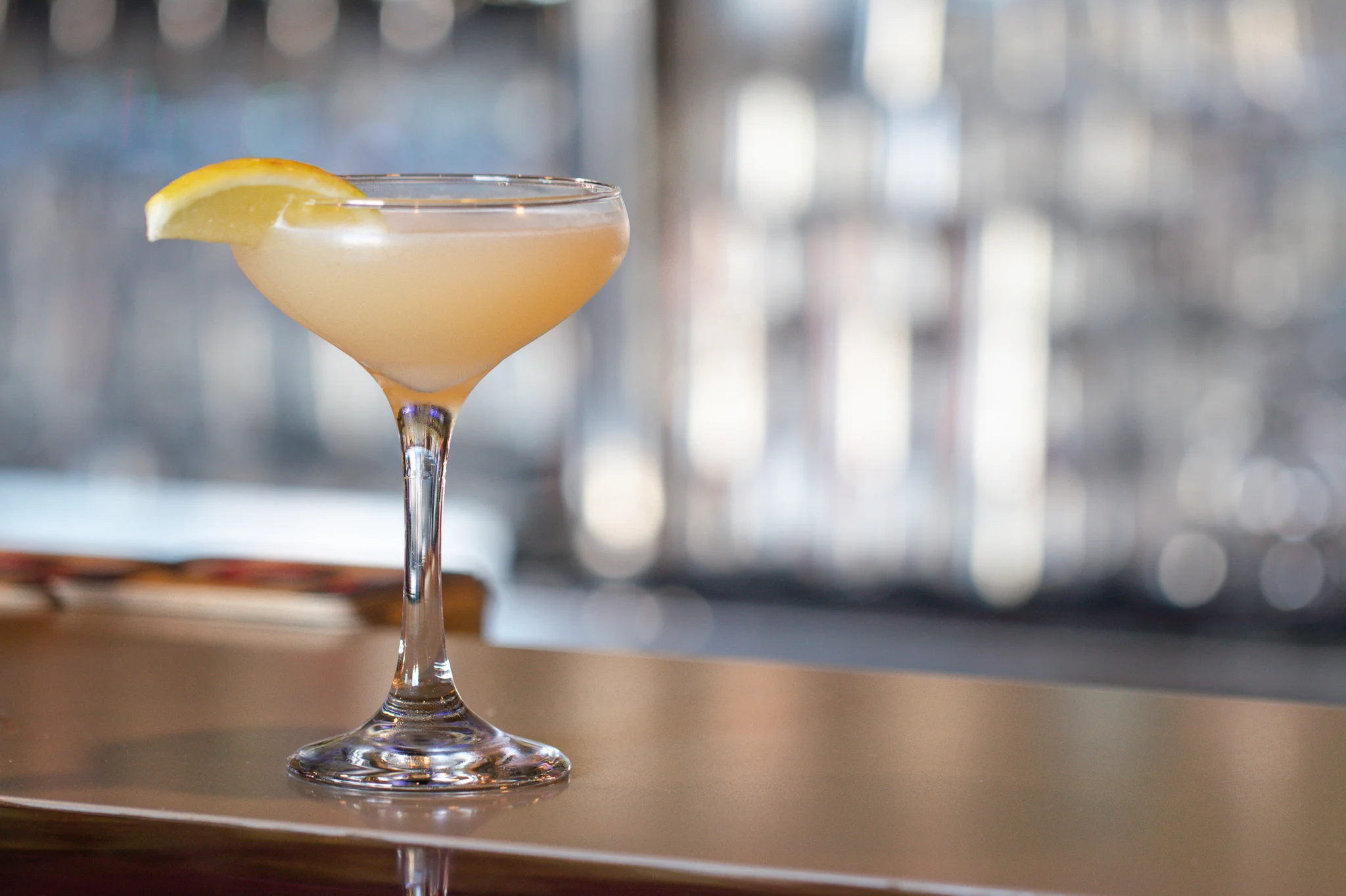 Classic cocktail served in a coupe glass with a lemon twist